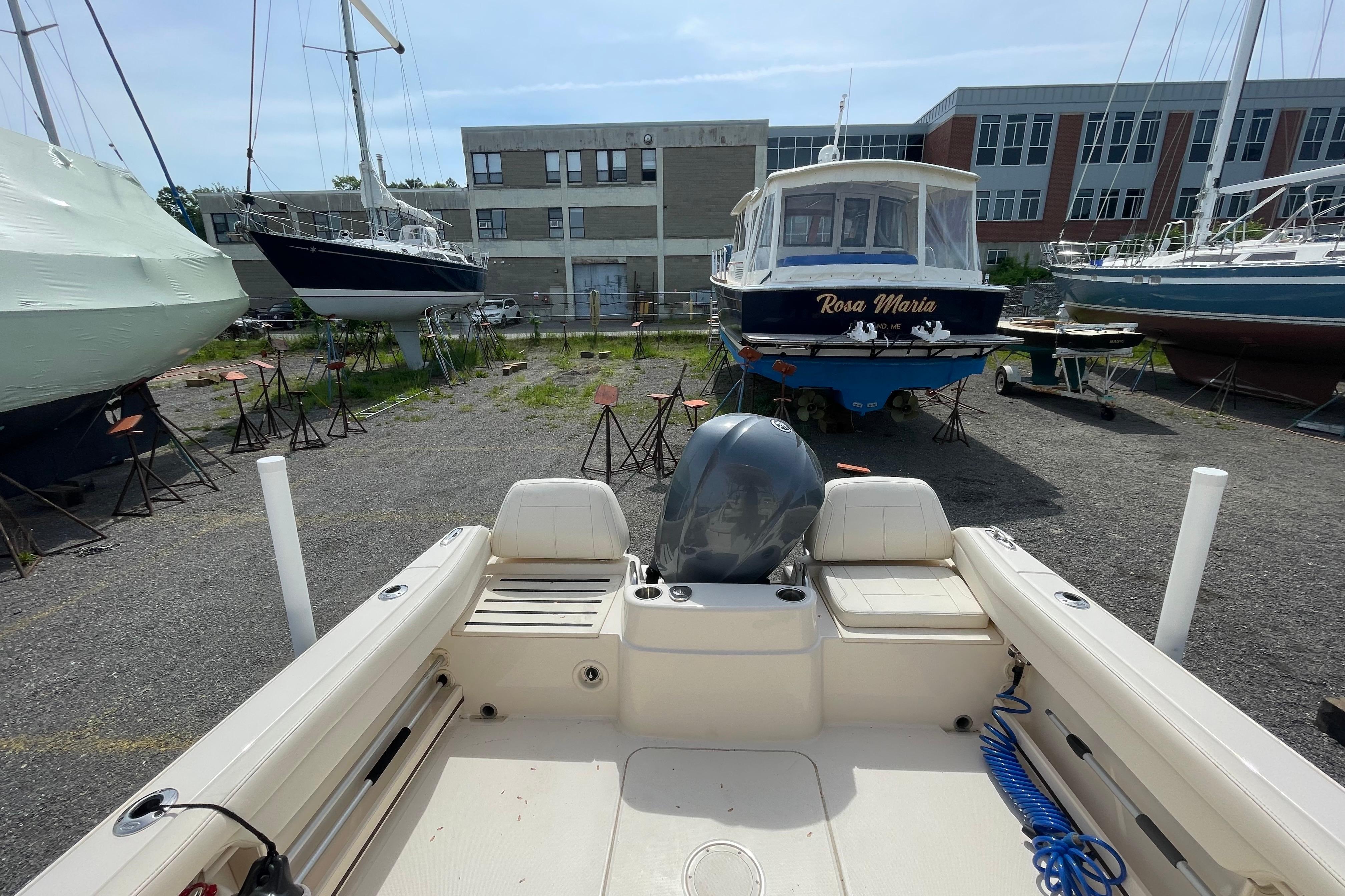 2024 Grady-White Adventure 218 boat in a marina with other vessels.