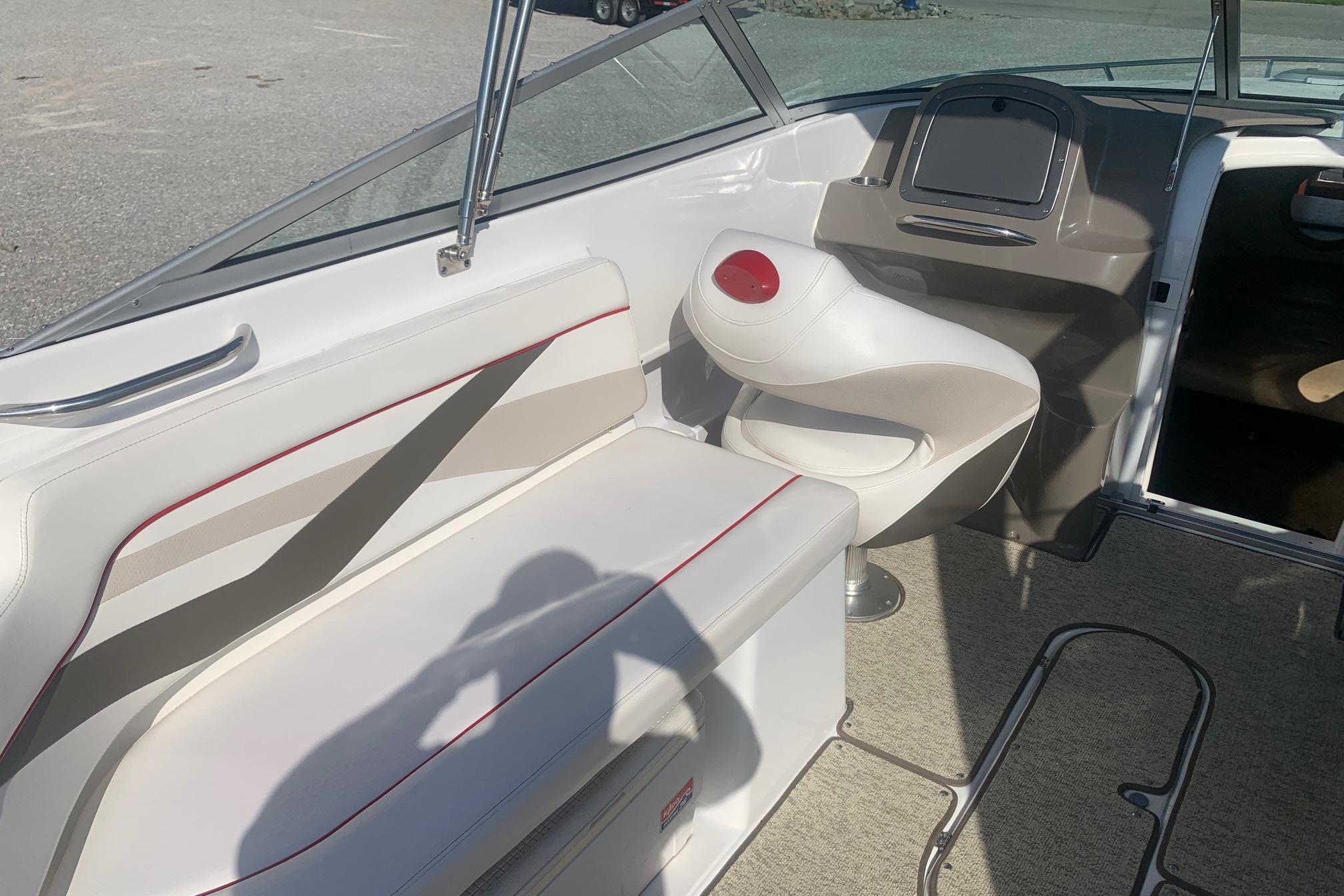 2006 Rinker 282 Captiva Cuddy interior with white seating and helm area.