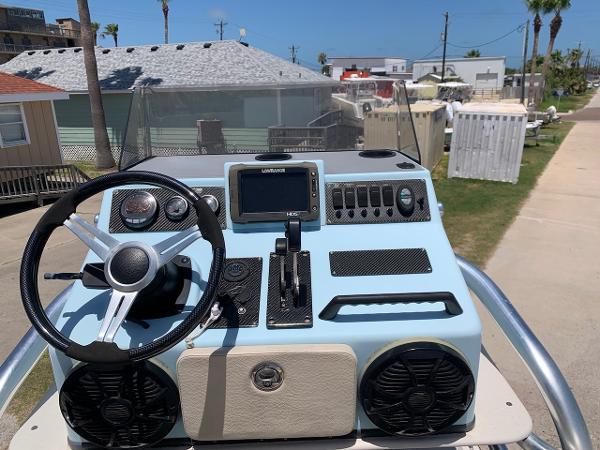 2013 SCB R24 boat dashboard with steering wheel, controls, and navigation system.