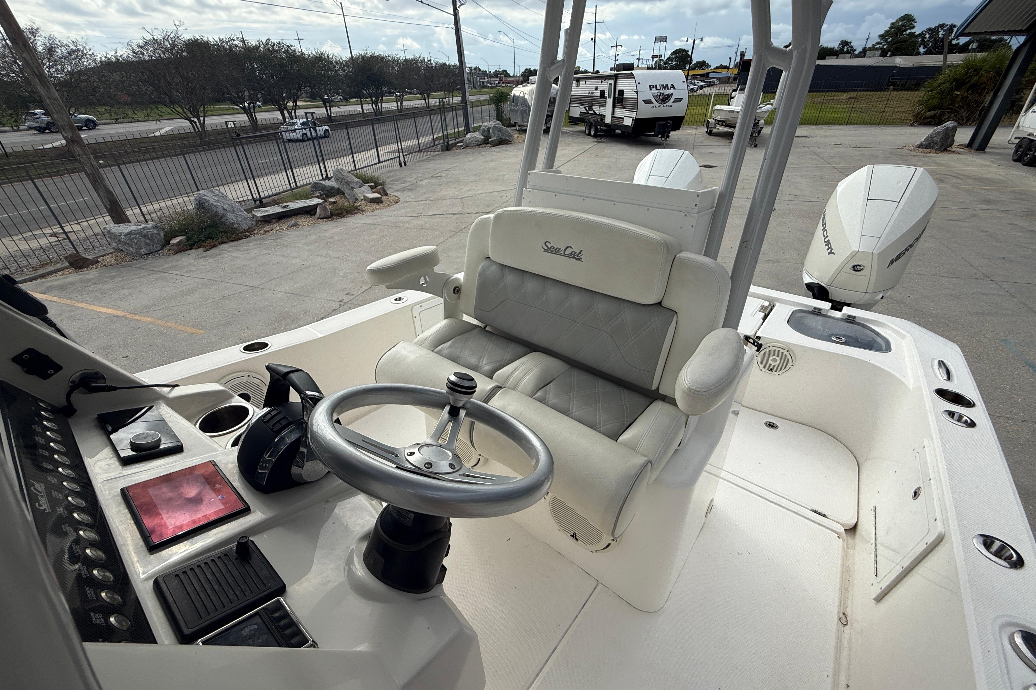 2021 Sea Cat 260 boat interior with steering wheel and dual Mercury engines.