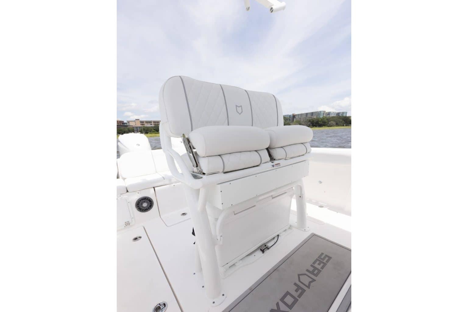 2027 Sea Fox 268 Commander boat seating with white cushioned bench and scenic water view.