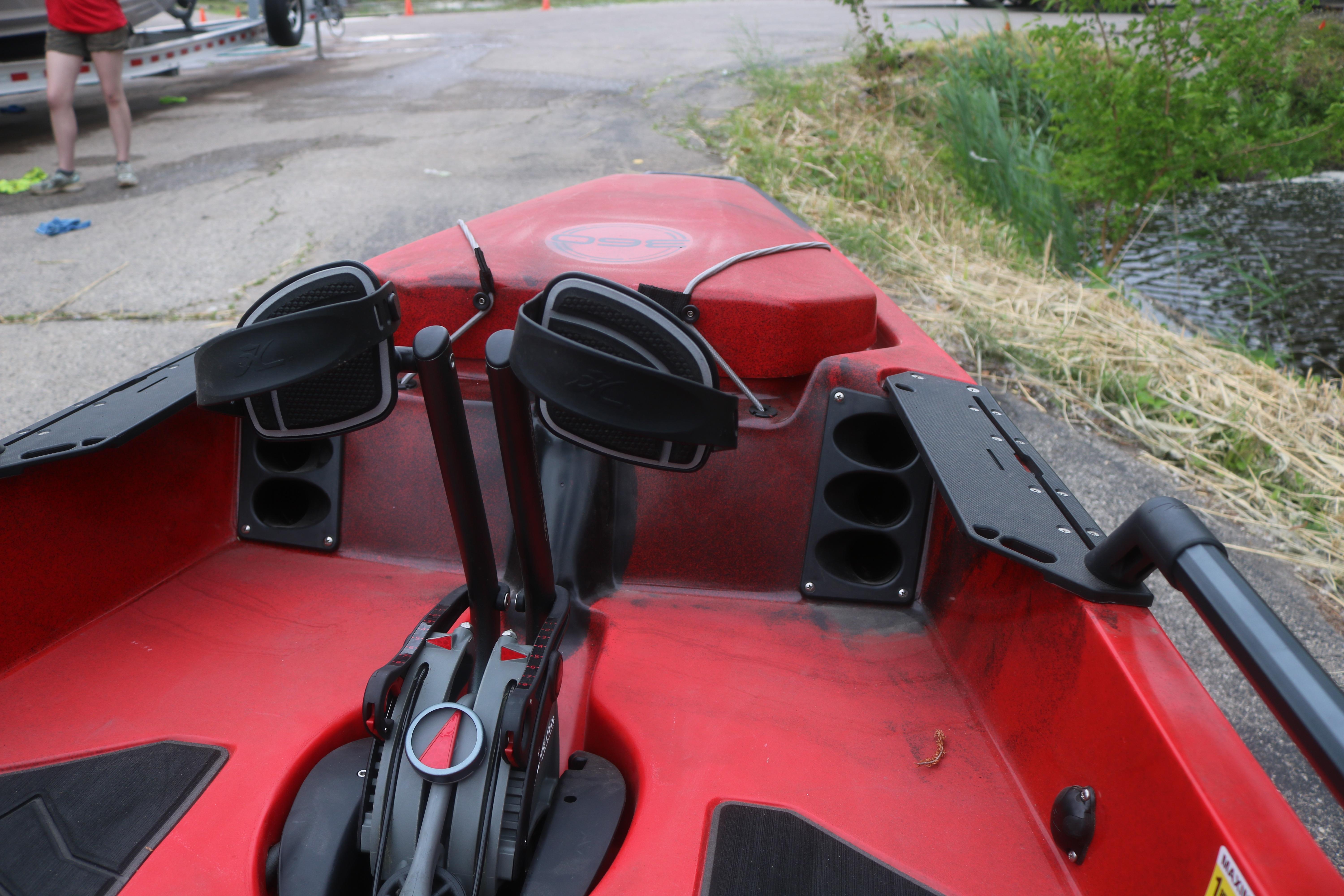 Red 2023 Hobie Mirage Pro Angler 14 kayak with pedal drive system, docked near water.