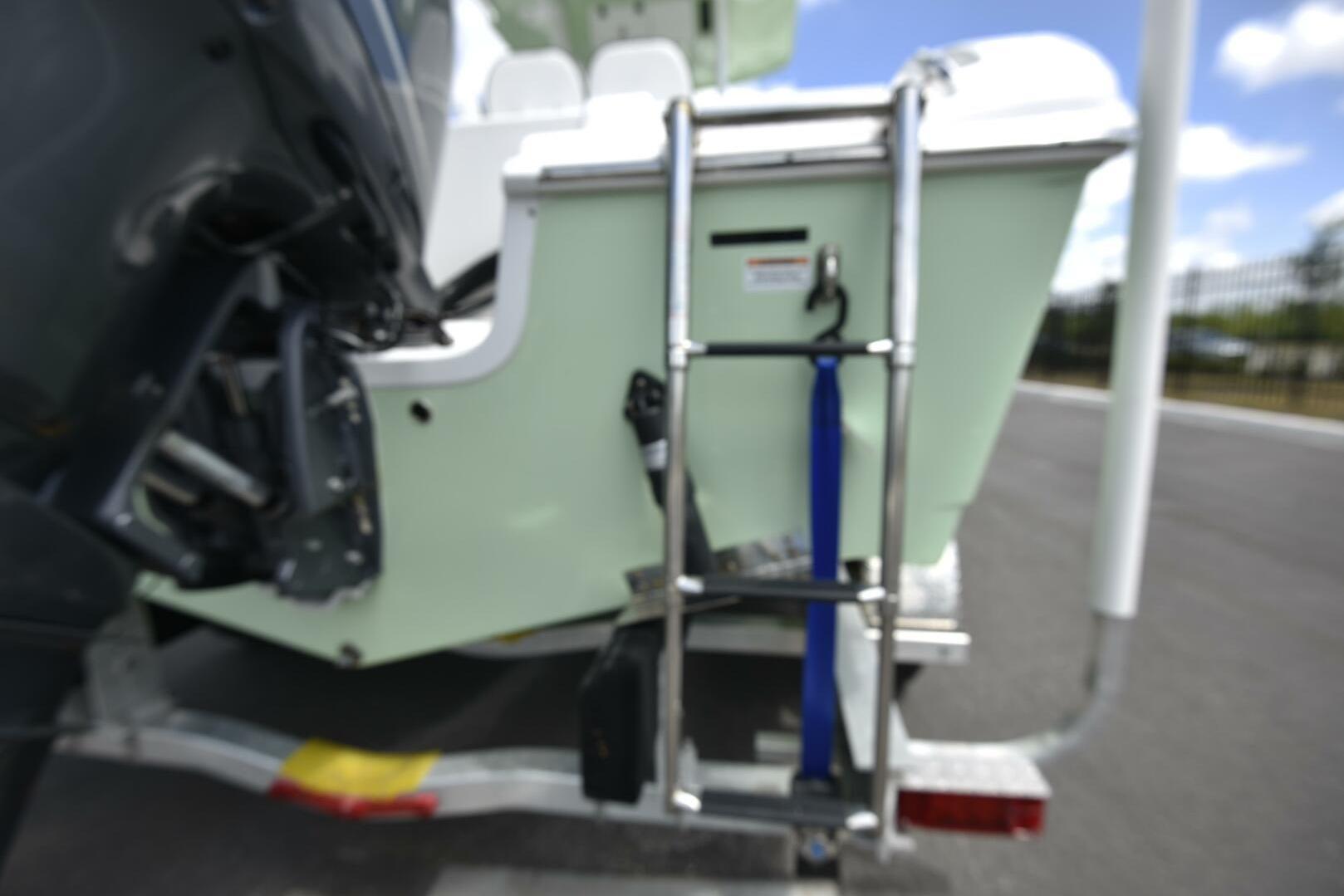 2023 Sea Pro 239 Deep V CC boat with ladder on trailer.