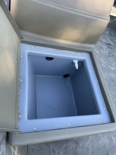2024 Tracker Grizzly 1754 SC boat storage compartment, open lid, interior view.