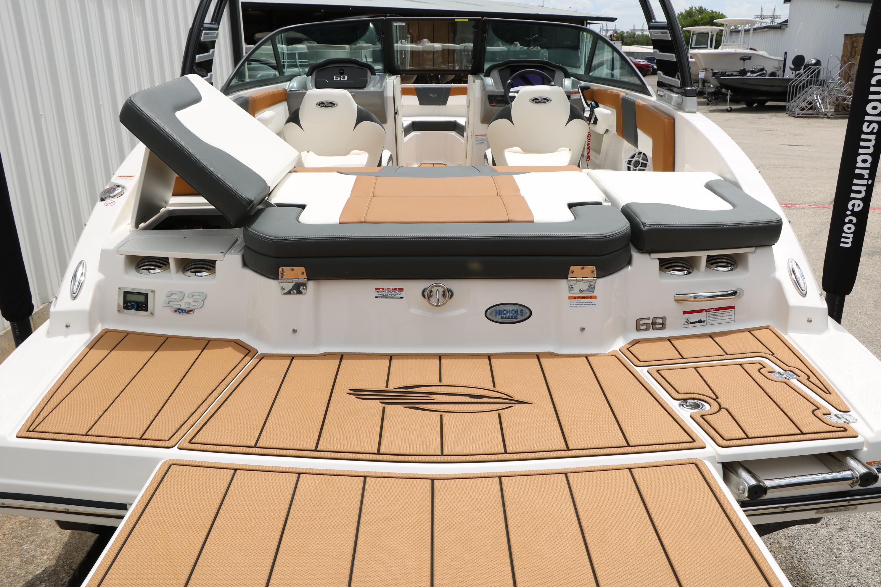 2025 Chaparral 23 SSi boat with tan deck and seating, docked at marina.