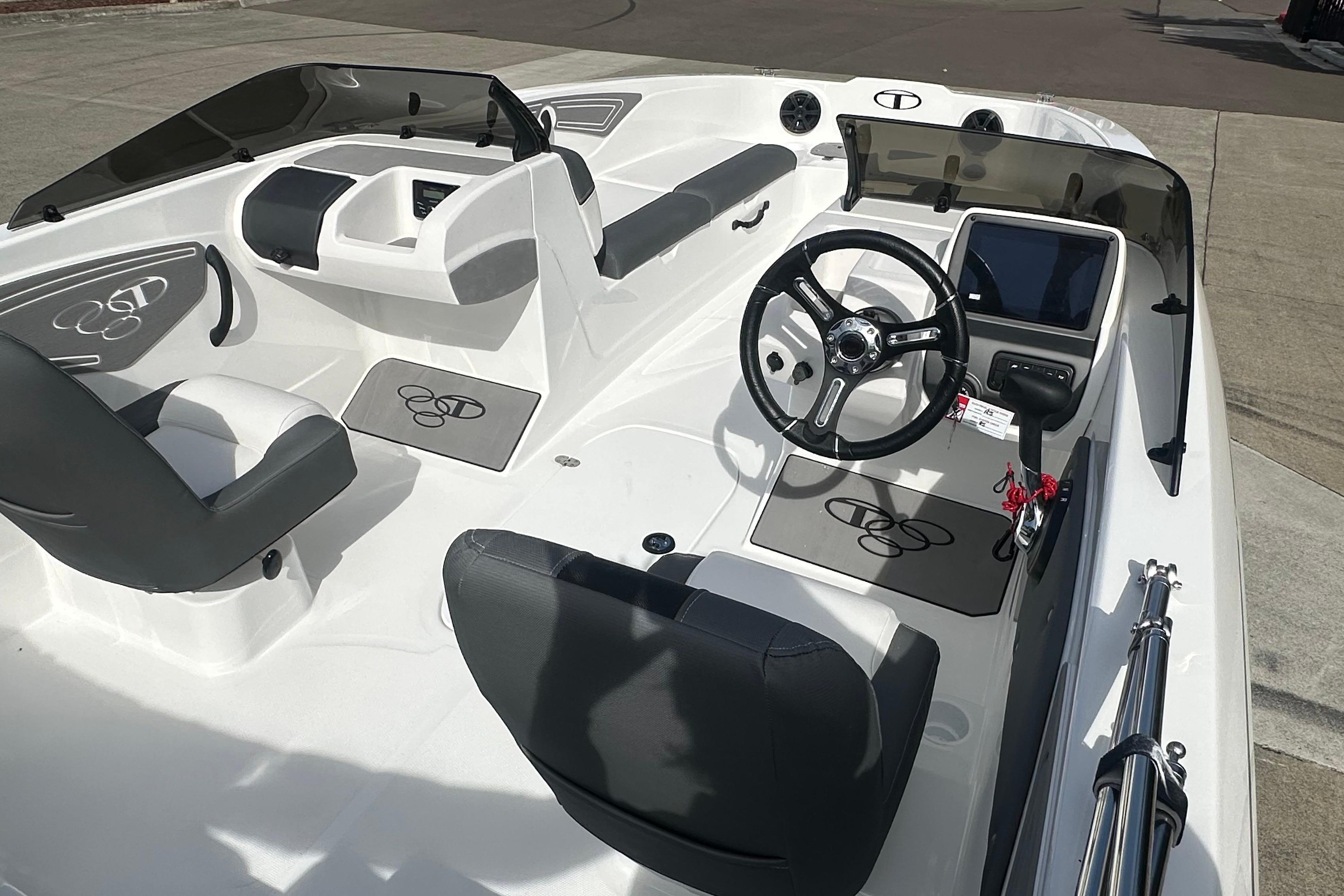 2026 Tahoe T21 boat interior with steering wheel, seating, and dashboard controls.