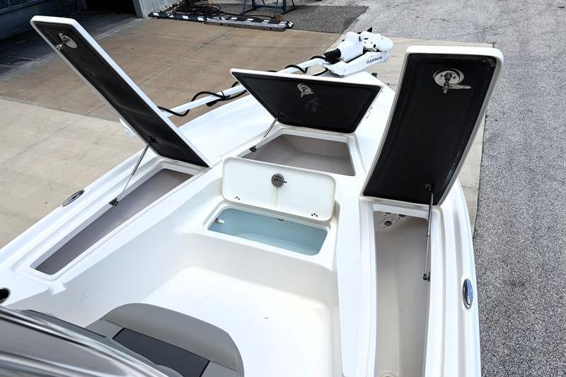 2025 Key West 210 Bay Reef boat with open storage compartments and sleek design.