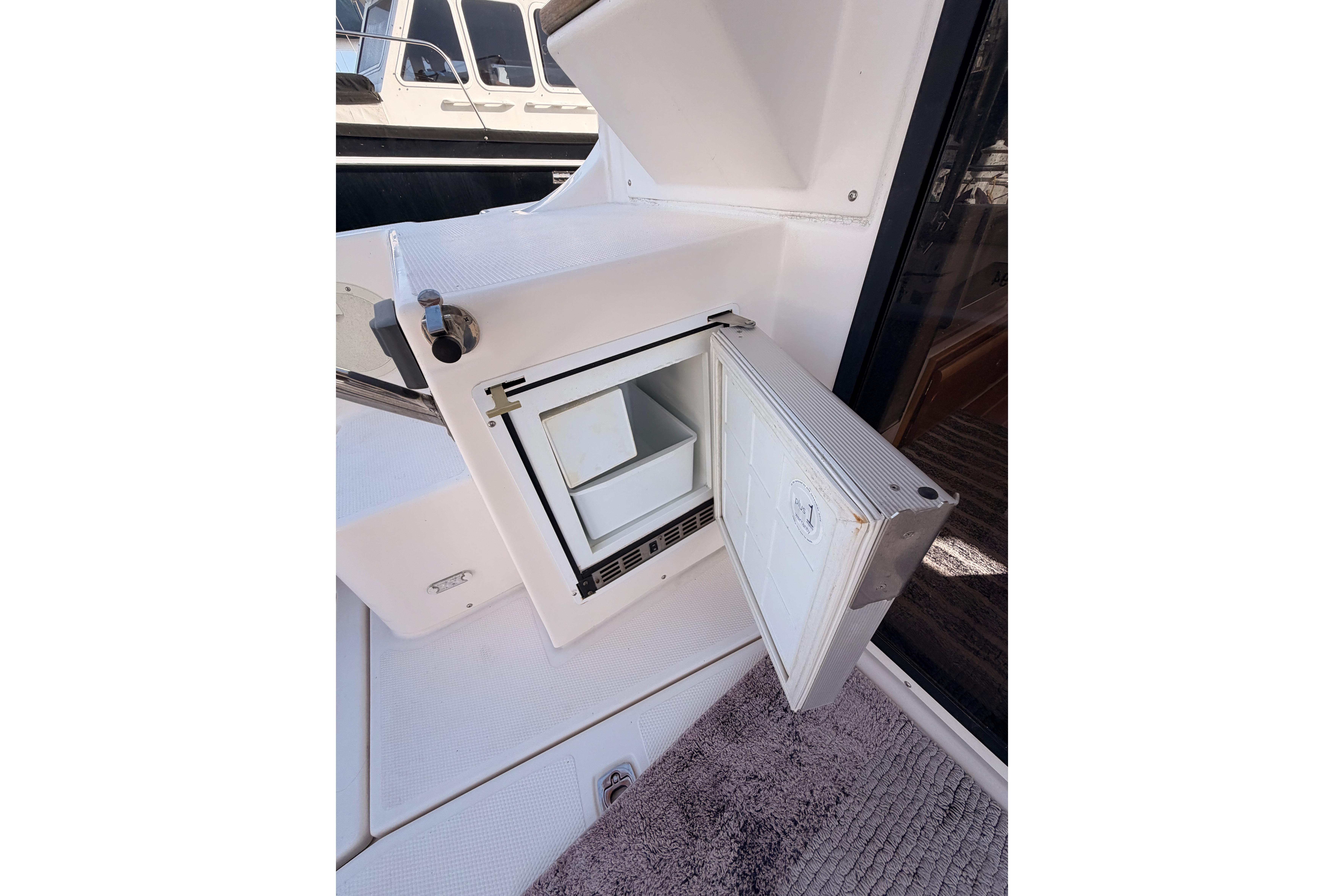 Open storage compartment on 2021 Cutwater C-32 CB boat deck.