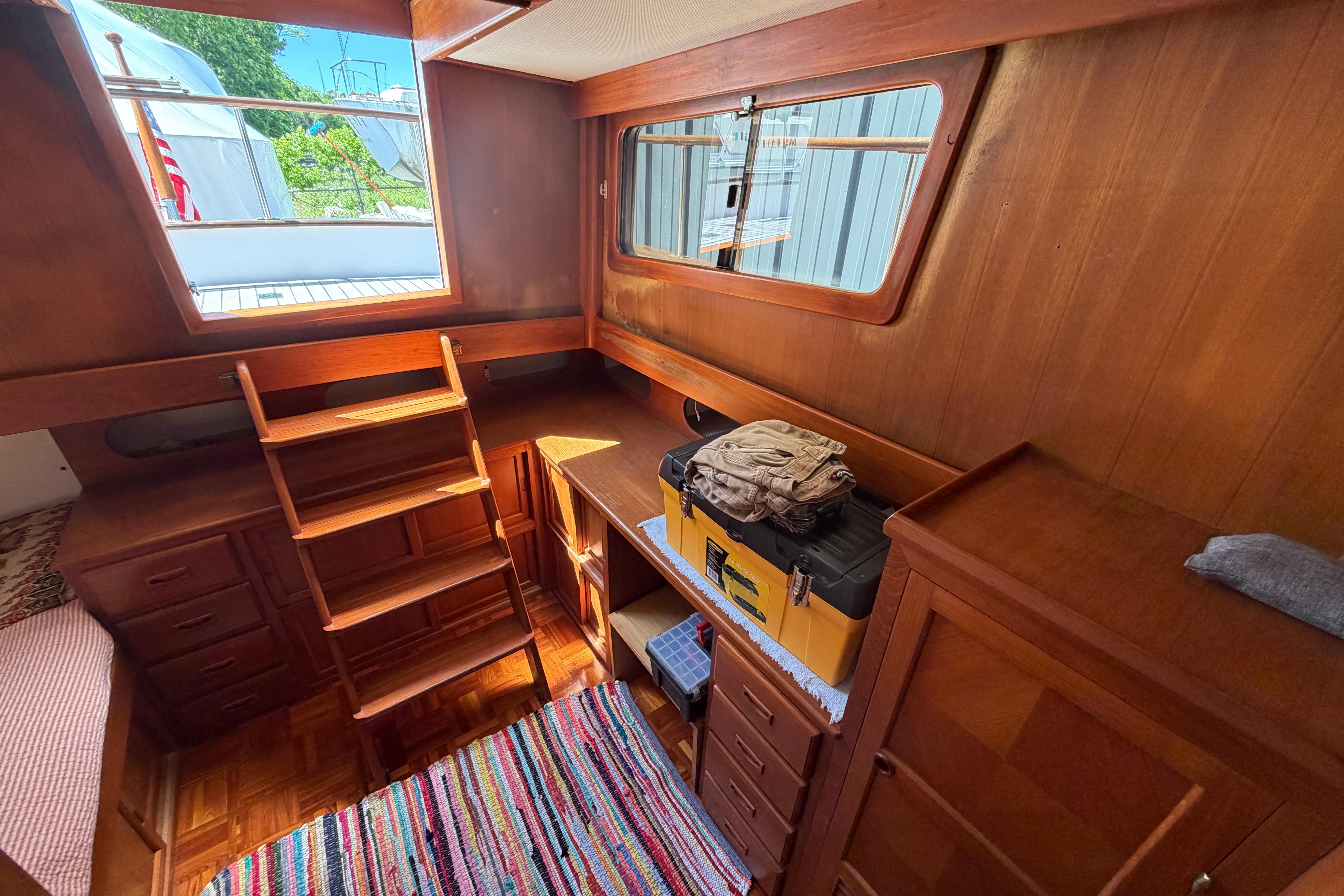 Interior of 1987 Marine Trader 36 boat with wooden cabinetry and ladder.