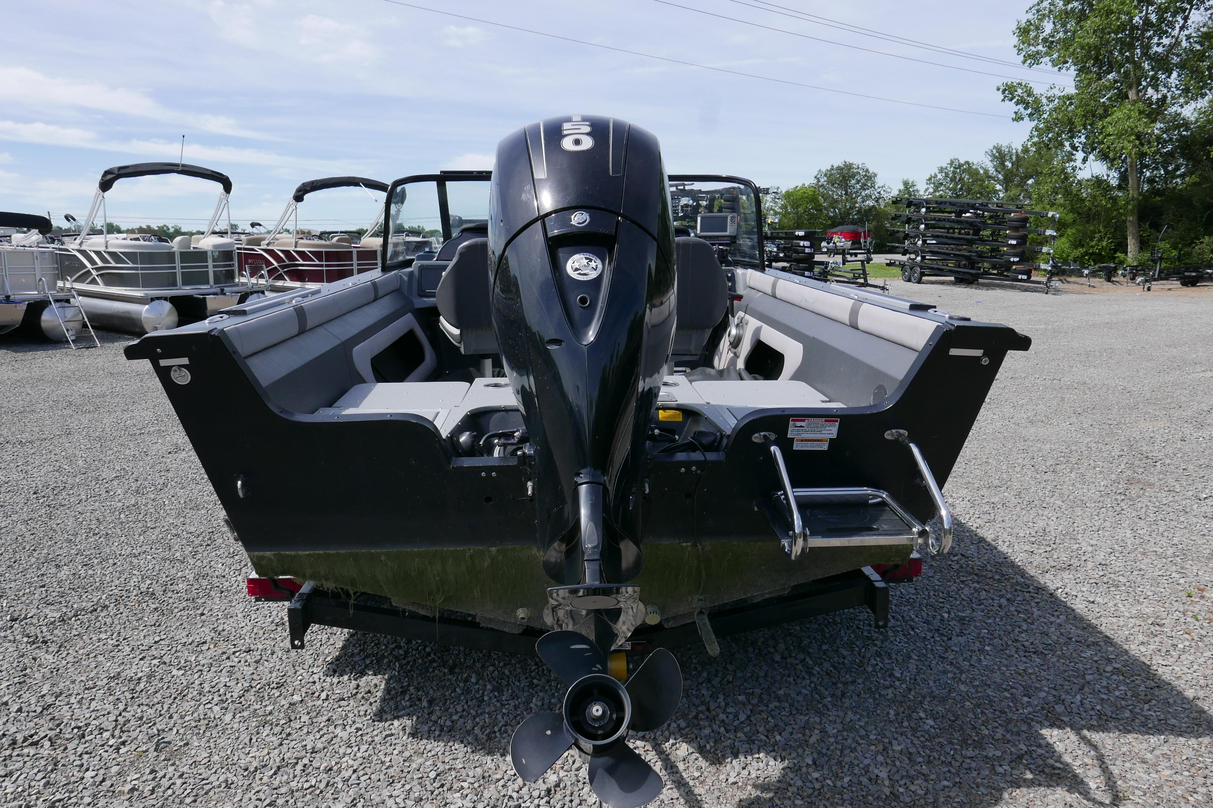 2016 Starcraft Titan 186 boat with outboard motor, parked on gravel lot.