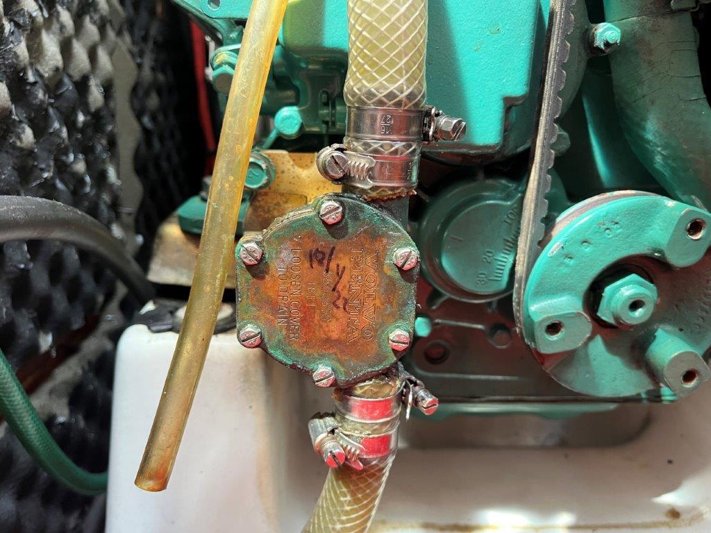 Engine component of 2002 Beneteau First 36.7 sailboat, featuring hoses and metal fittings.