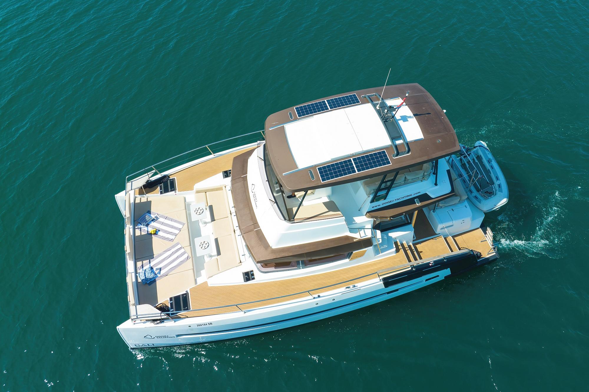 Aerial view of 2020 Bali 4.3 MY catamaran cruising on clear blue water.