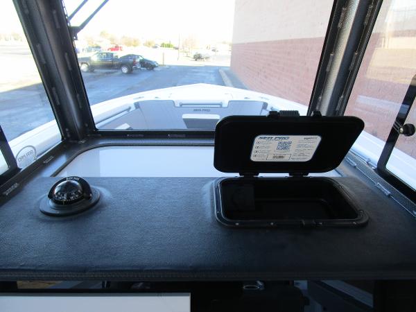 2025 Sea Pro 292 Offshore dashboard with compass and storage compartment.