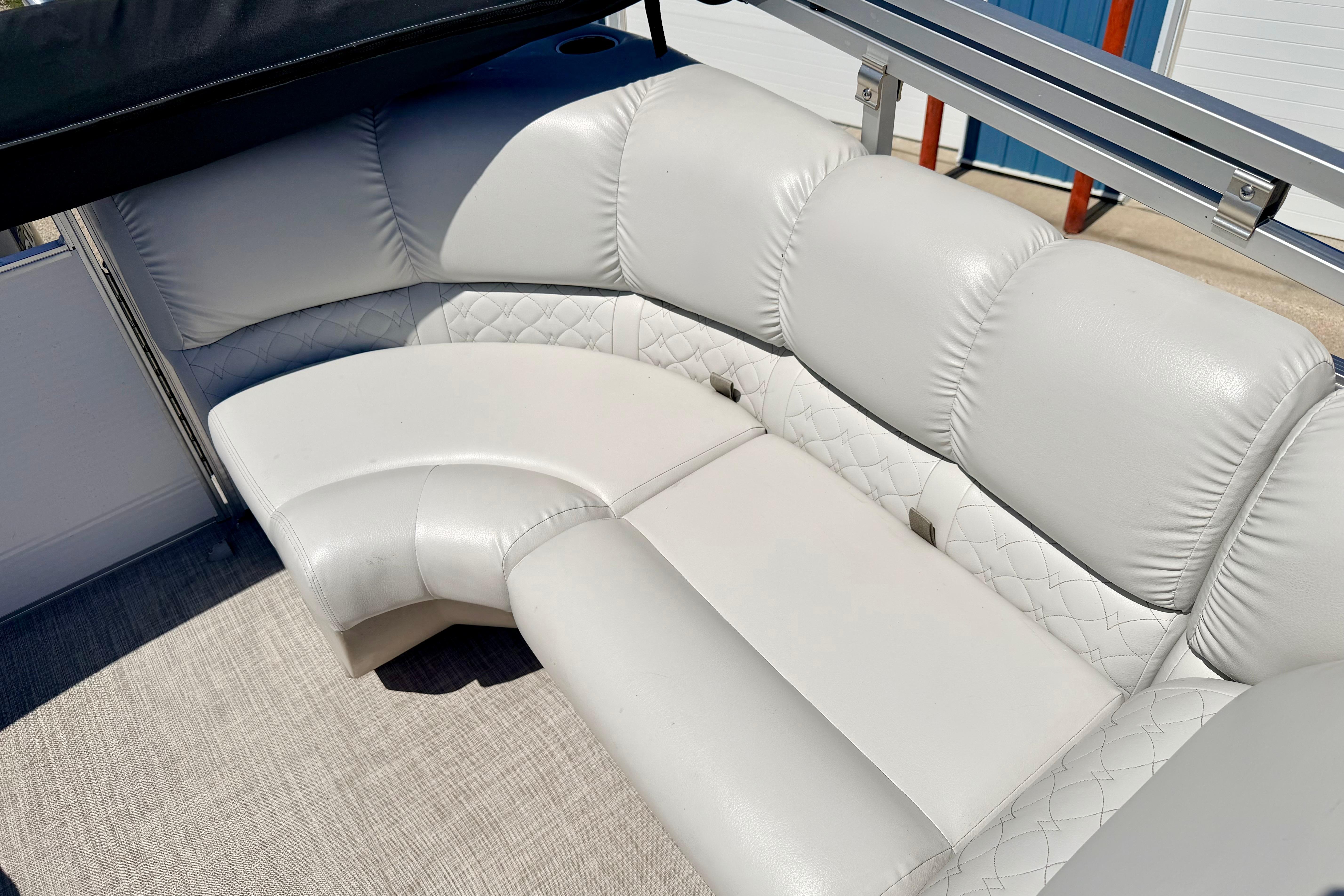 Luxurious seating on 2019 Crestliner 240 Rally DX CW boat, featuring plush white upholstery.