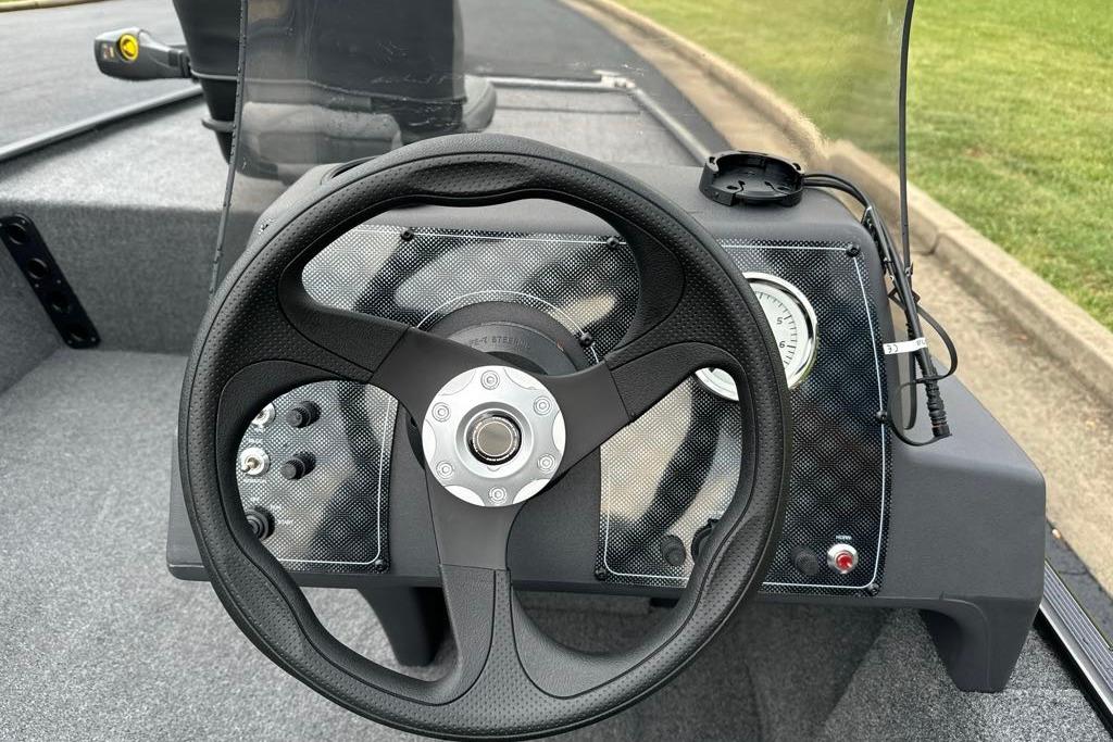 Steering wheel of 2026 Tracker Bass Tracker Classic XL boat, featuring modern dashboard design.