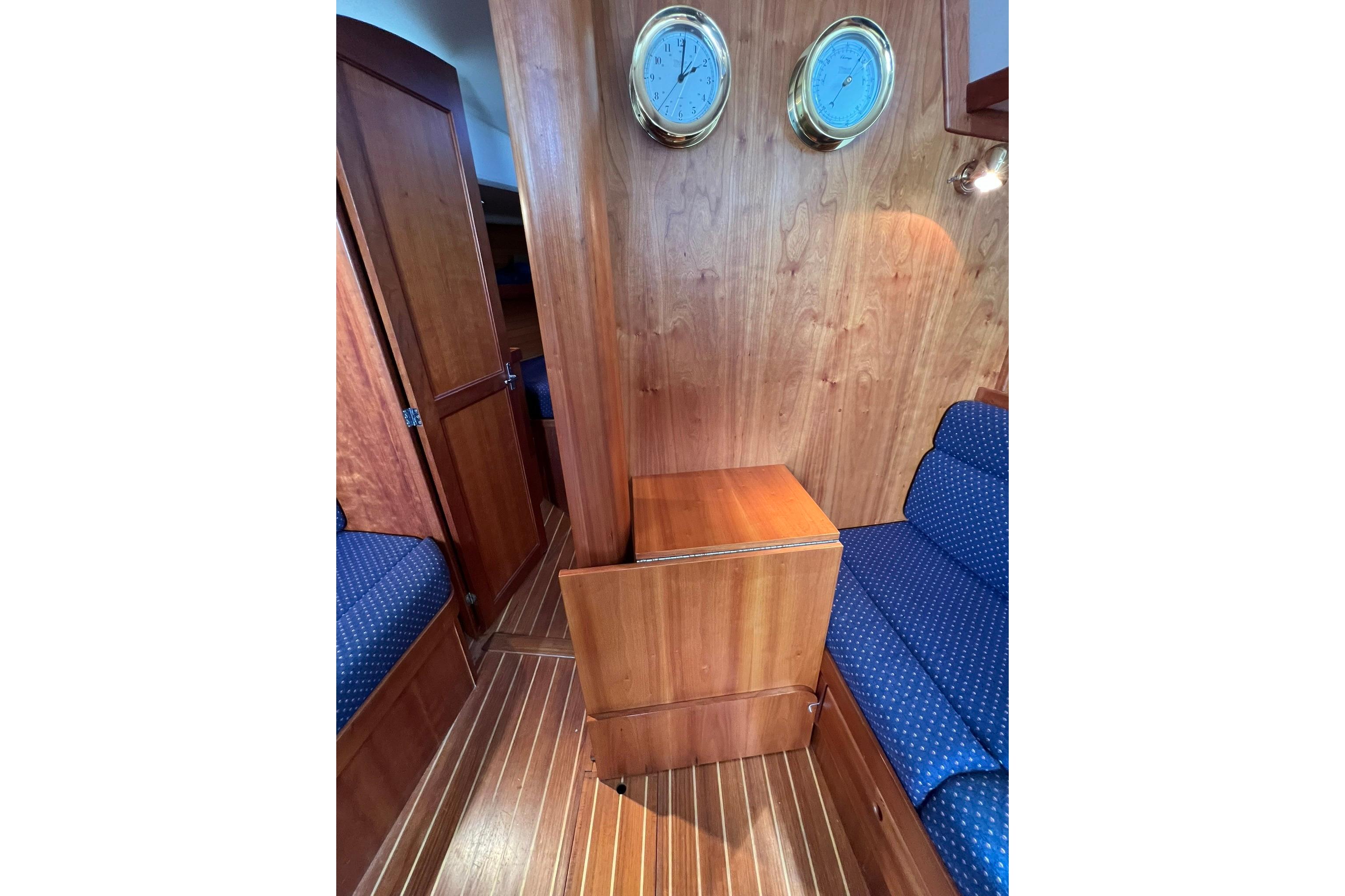 Interior of 1998 Sabre 362 yacht with wooden paneling and blue upholstered seating.
