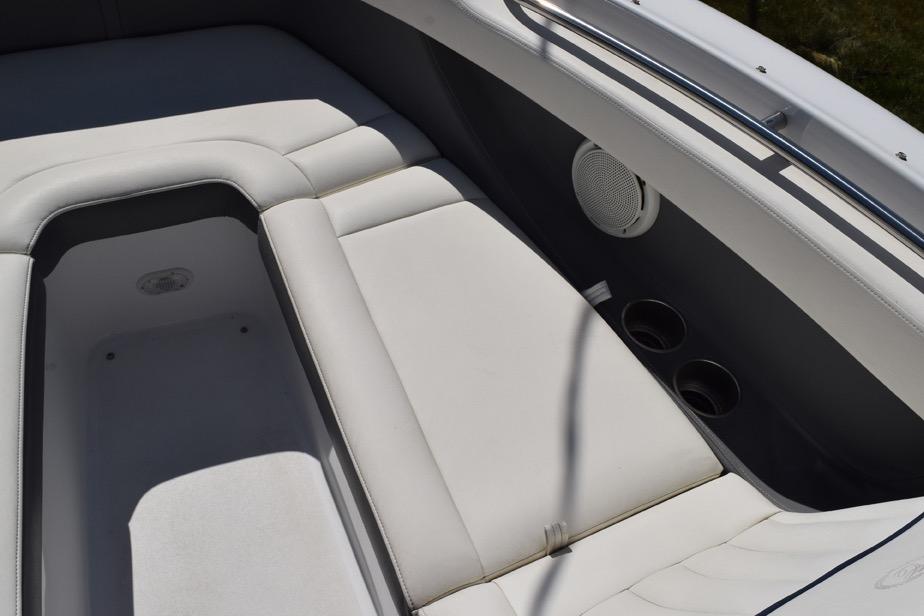 Interior seating of a 2006 Cobalt 240 boat with cup holders and speaker.