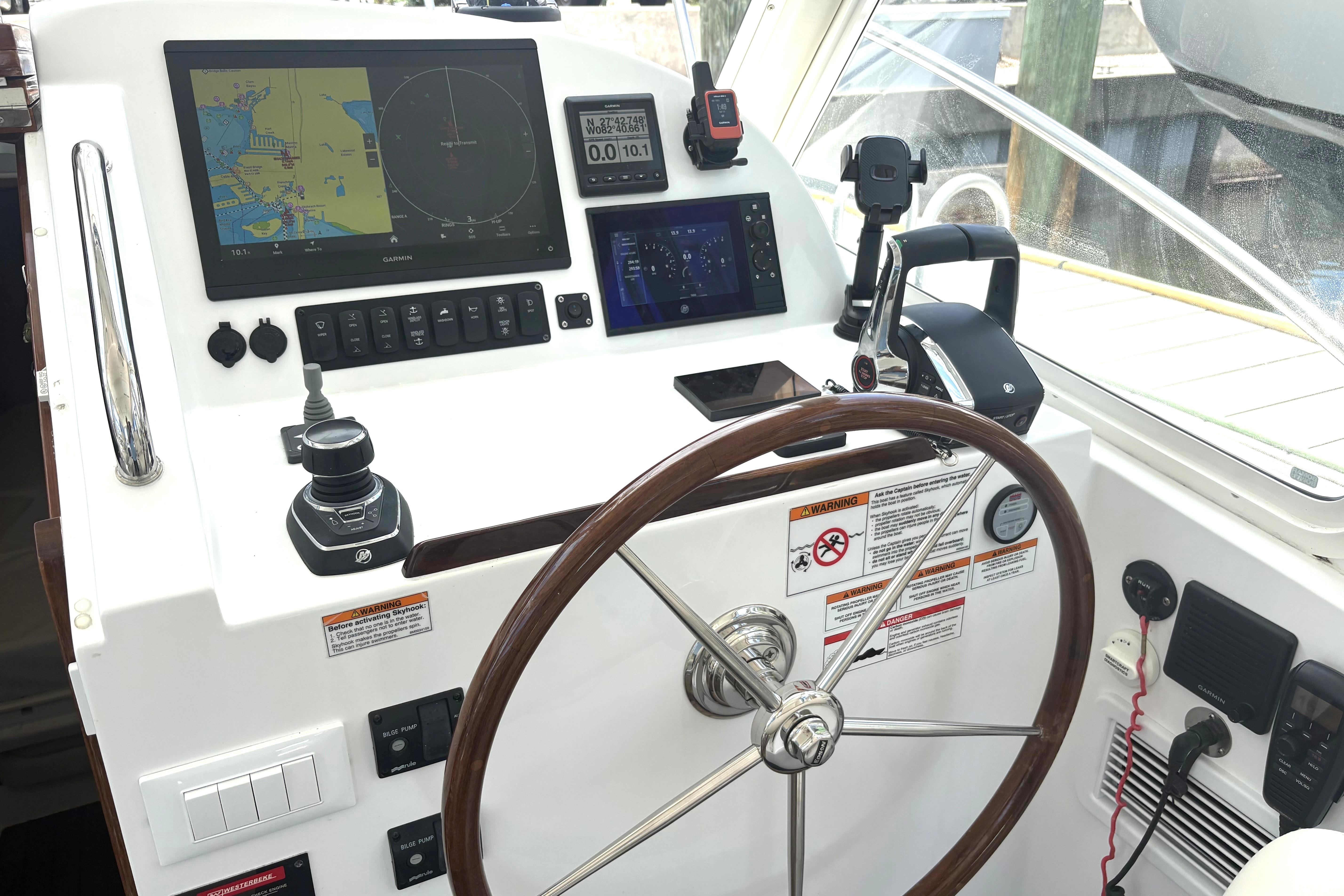2024 MJM 35z helm with navigation screens, joystick, and steering wheel.