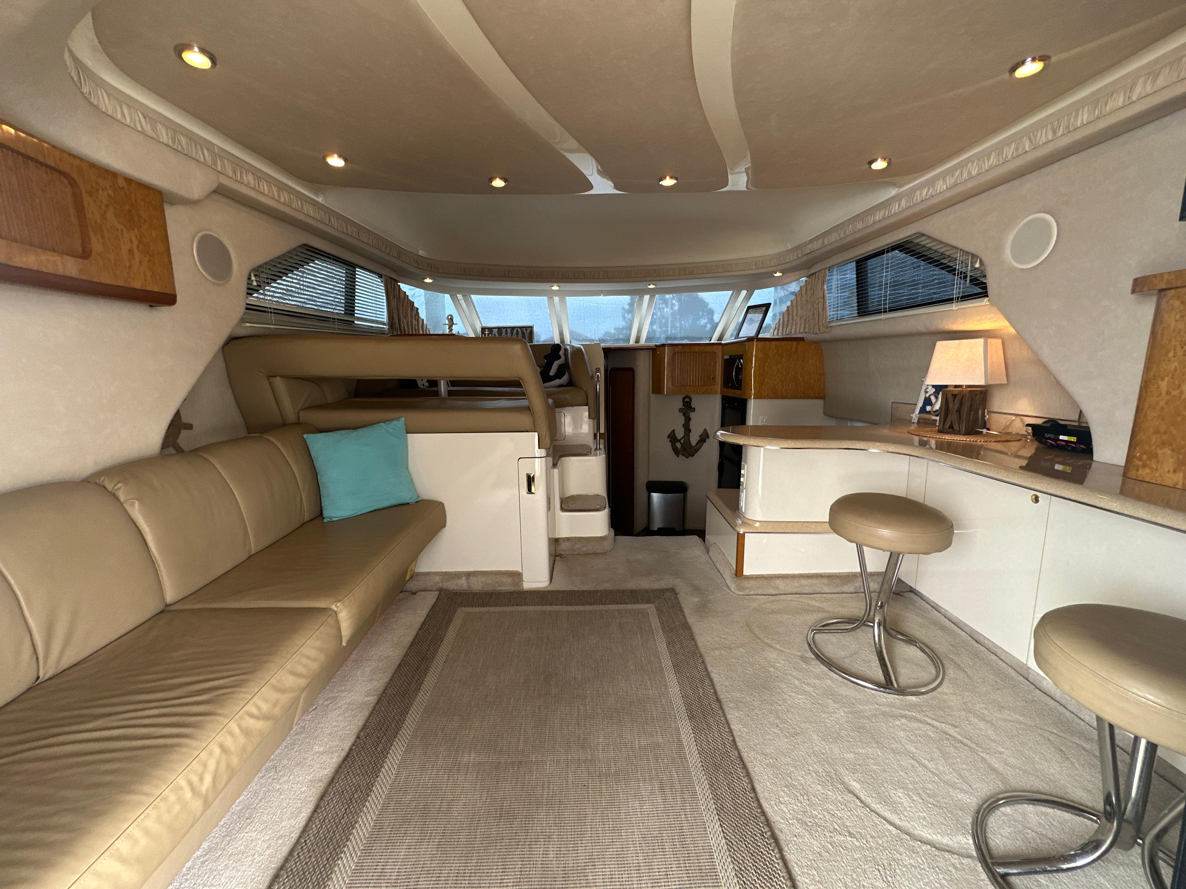 Interior of 1997 Sea Ray 400 Sedan Bridge yacht with beige seating and modern decor.
