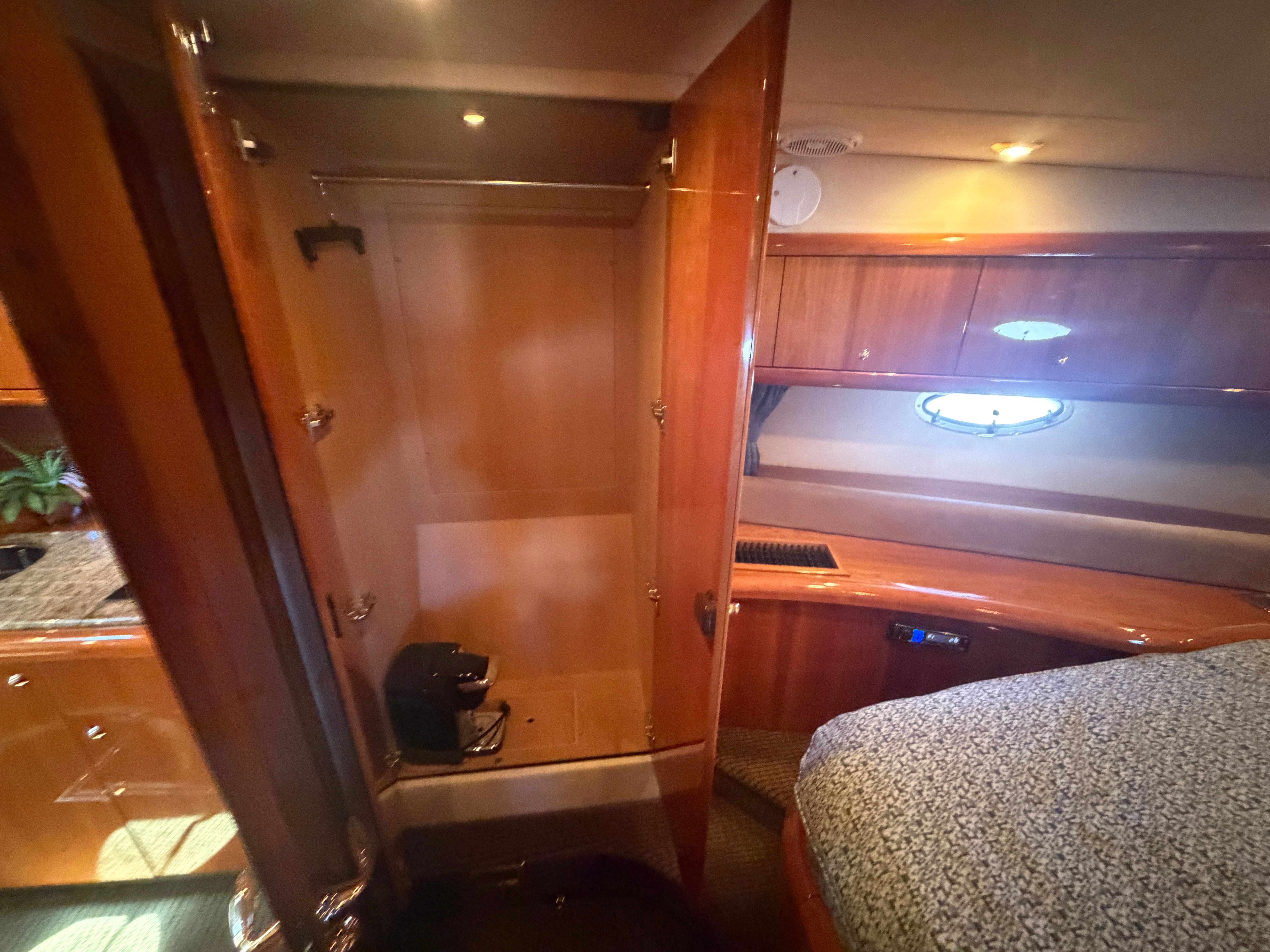 Interior of a 2008 Sunseeker Portofino 53 with wooden furnishings and a bed.