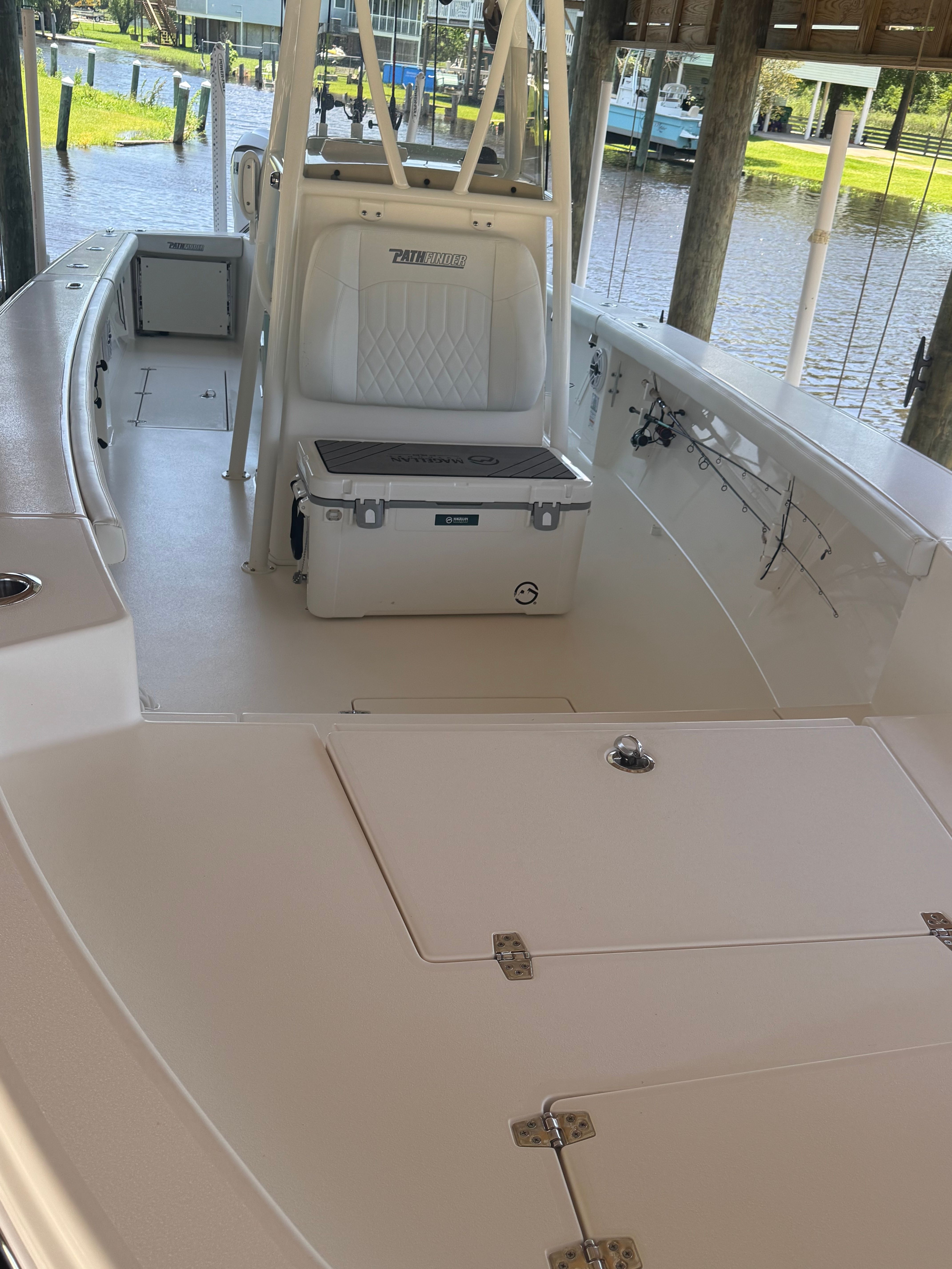 2024 Pathfinder 2700 Open boat deck with seating and cooler.