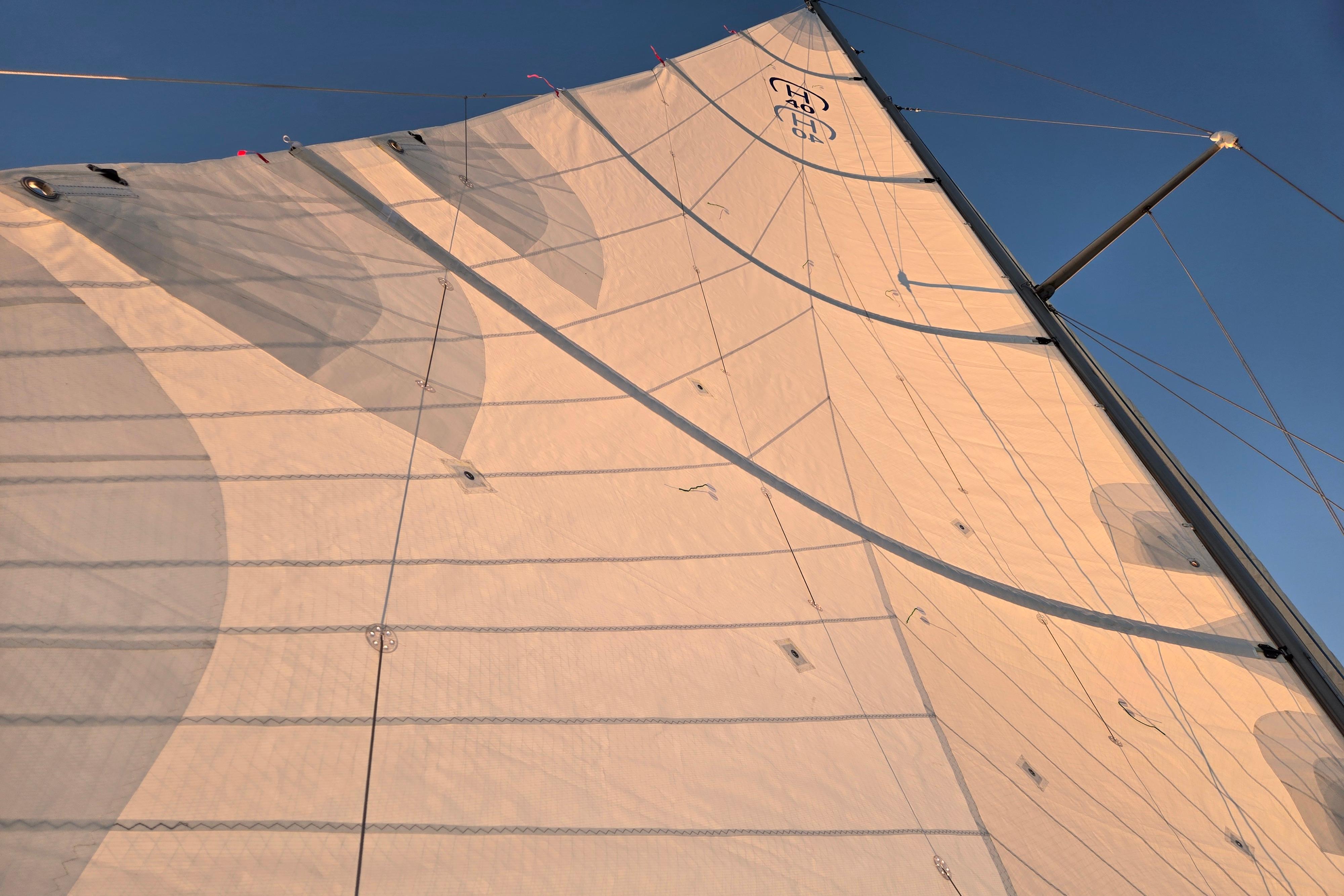 Sail of a 1970 Hinckley Bermuda 40 yacht against a clear blue sky.
