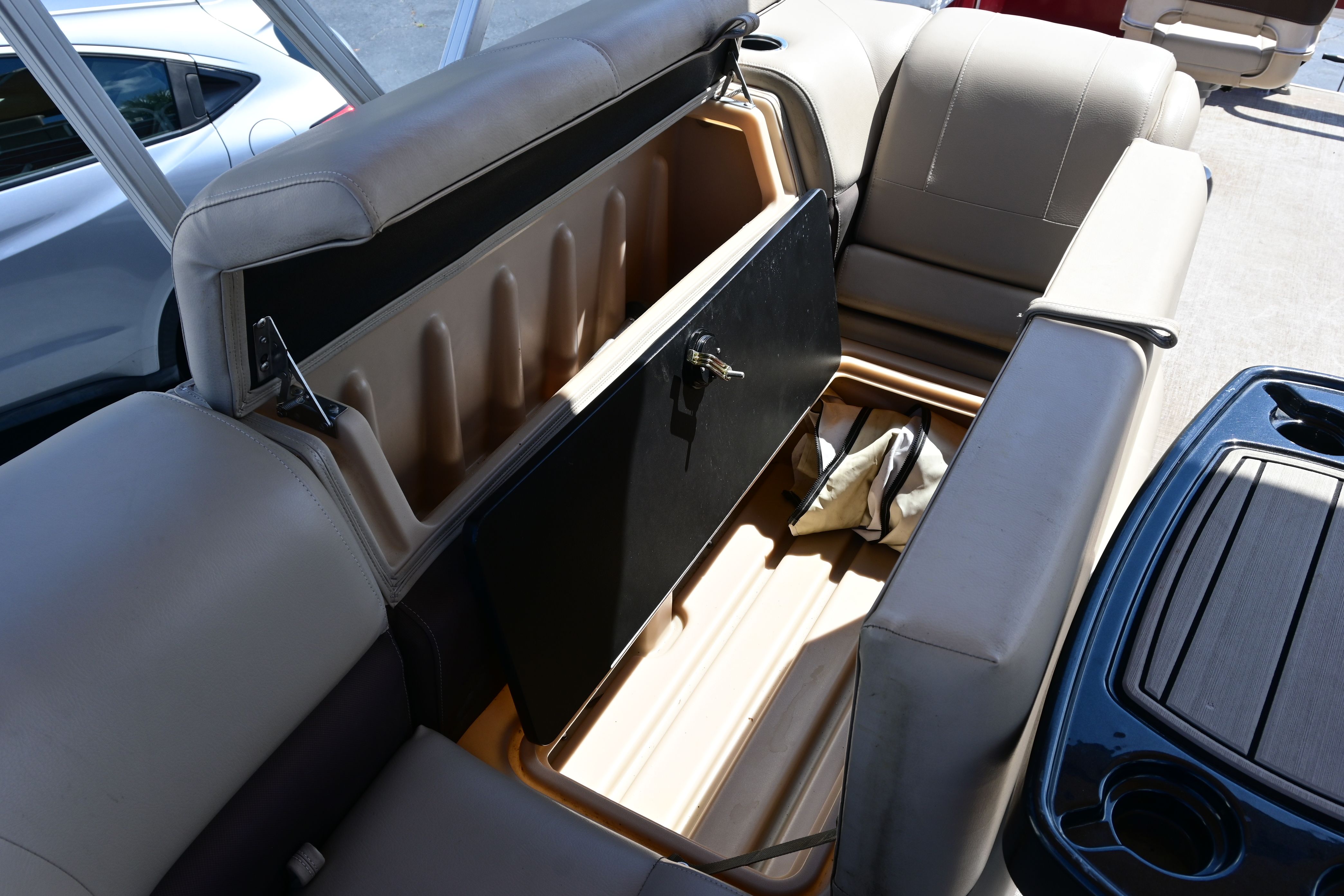 2019 Sun Tracker FISHI boat with open storage compartment.