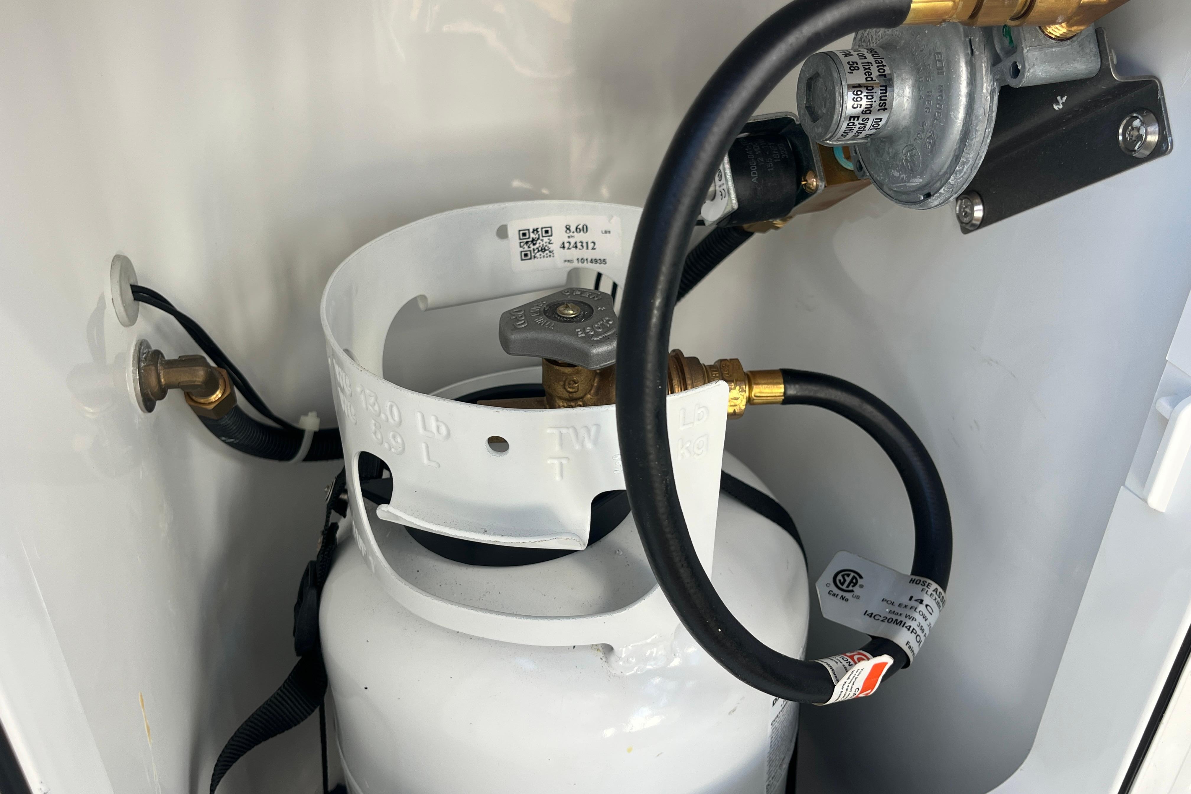 Propane tank setup in a 2025 Hanse 360 yacht, featuring hoses and connectors.