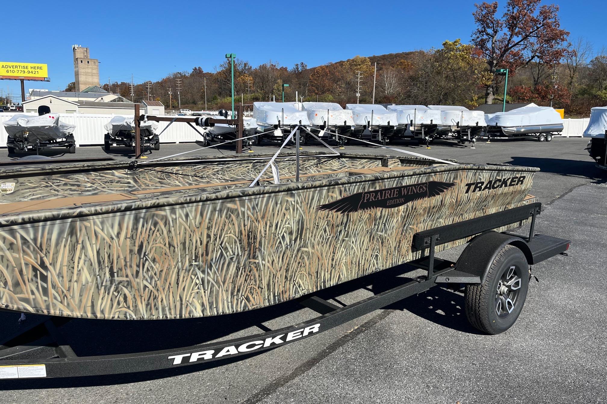 2026 Tracker Grizzly 1650 T Prairie Wings Edition boat with camouflage design on a trailer.
