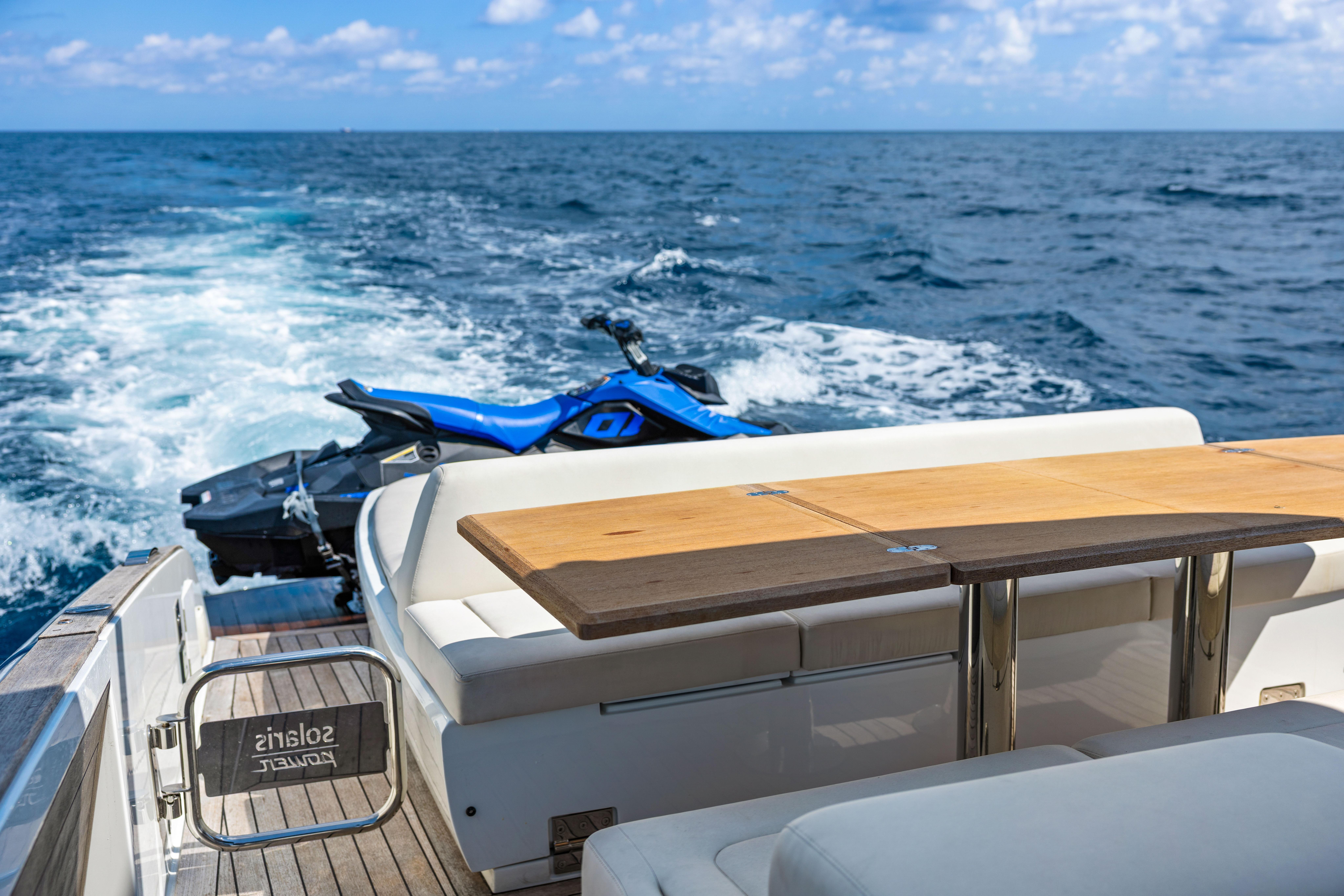 Luxury 2024 Solaris Power 44 yacht with jet ski on open sea.