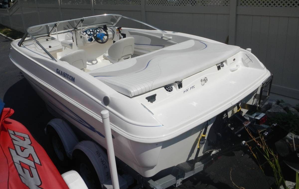A white 2006 Glastron MX-195 Limited Edition boat on a trailer, featuring an open cockpit.