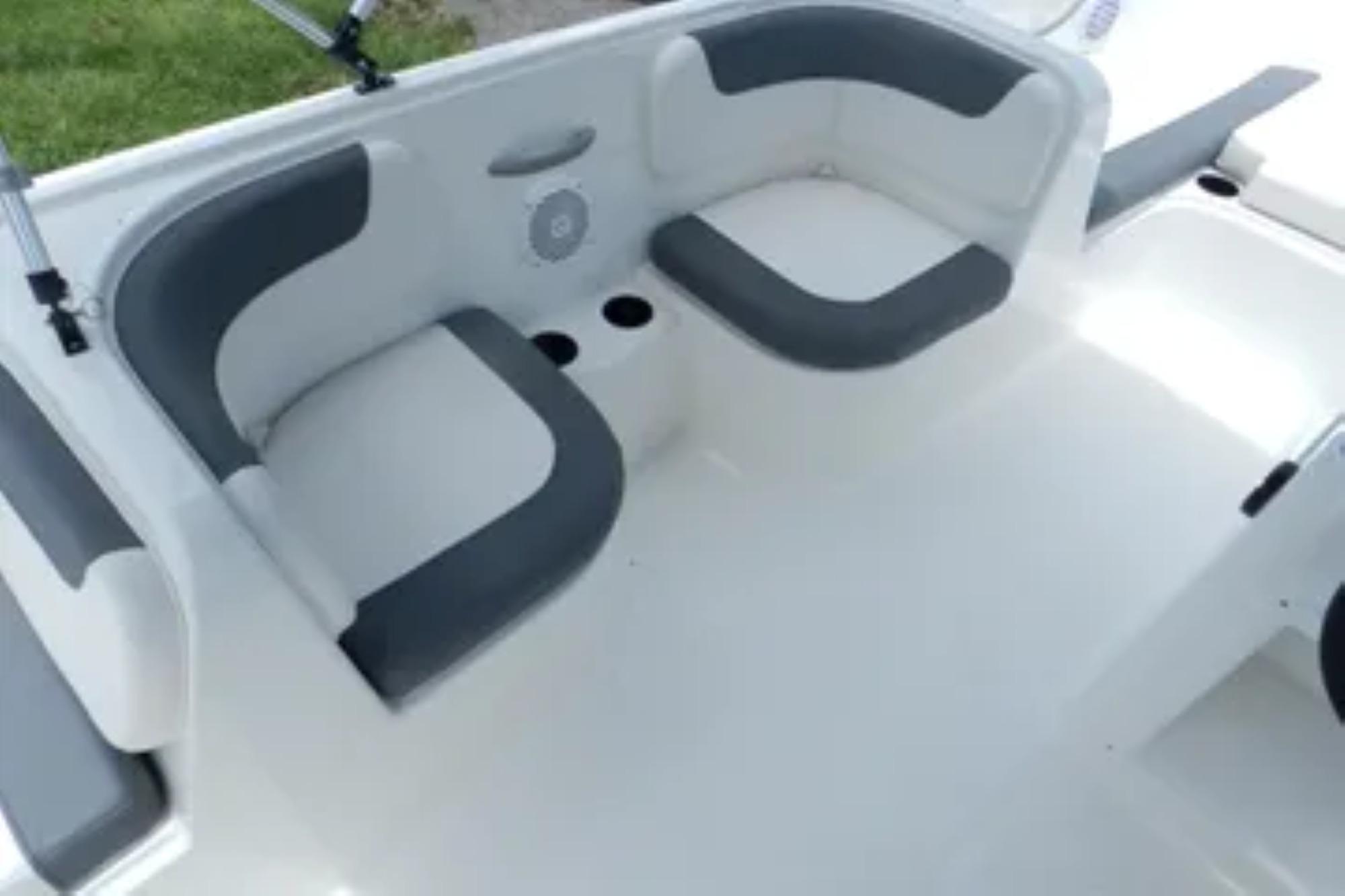 2026 Bayliner Element E18 boat interior with gray and white seating arrangement.