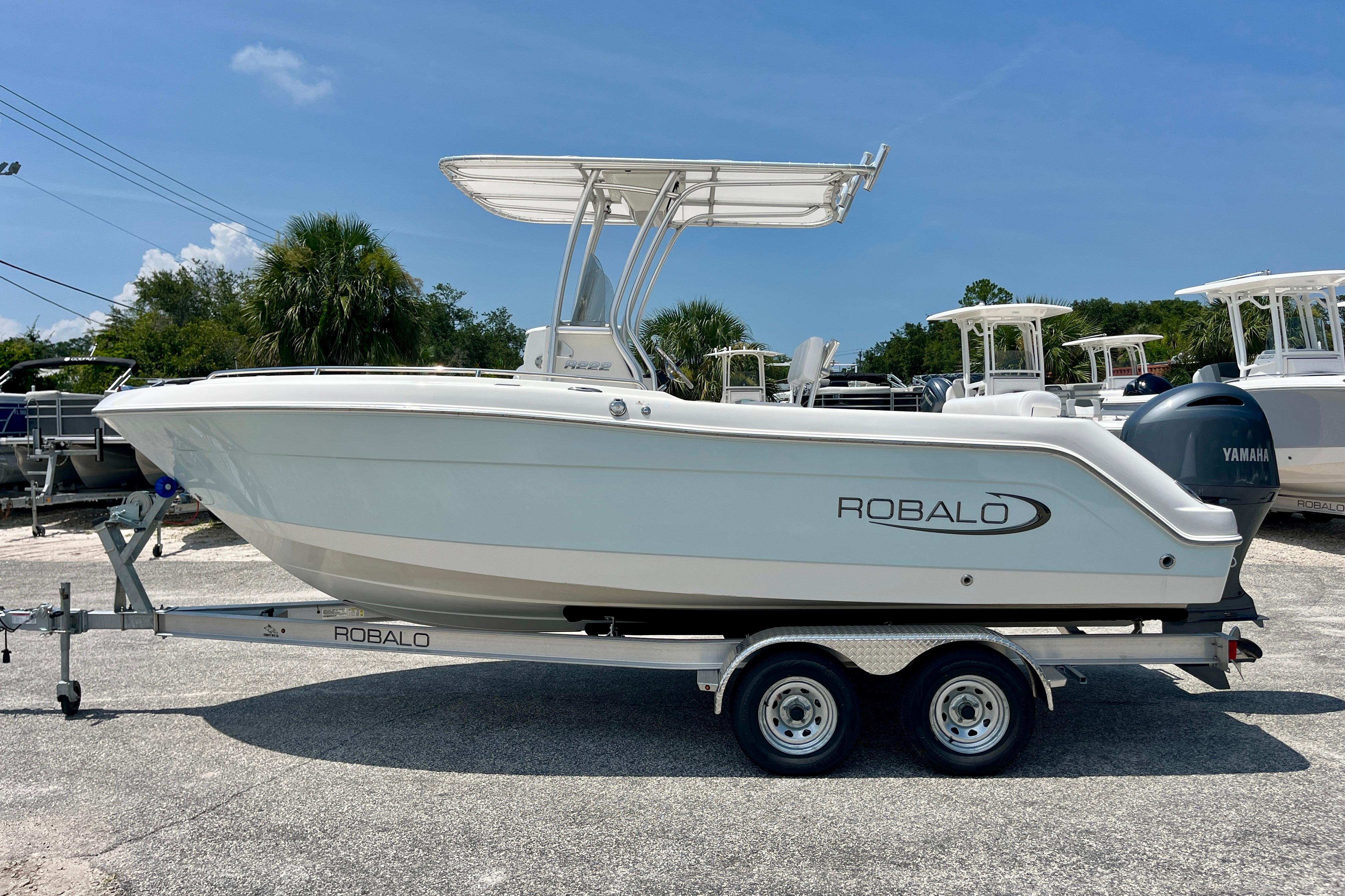 2016 Robalo R222 Center Console boat on trailer, sunny day background.