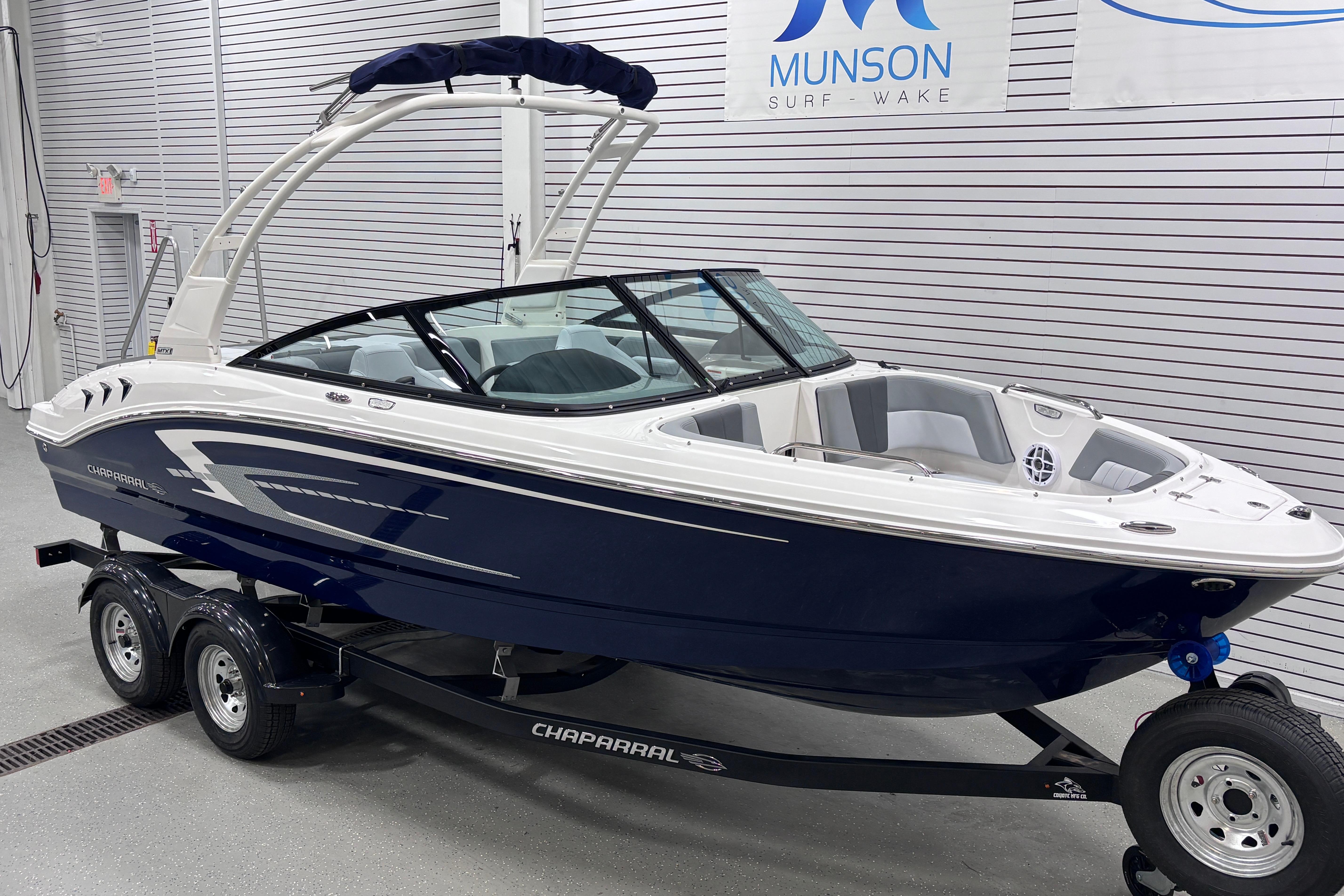 2026 Chaparral 21 SSi boat on trailer in showroom, Munson Surf Wake.