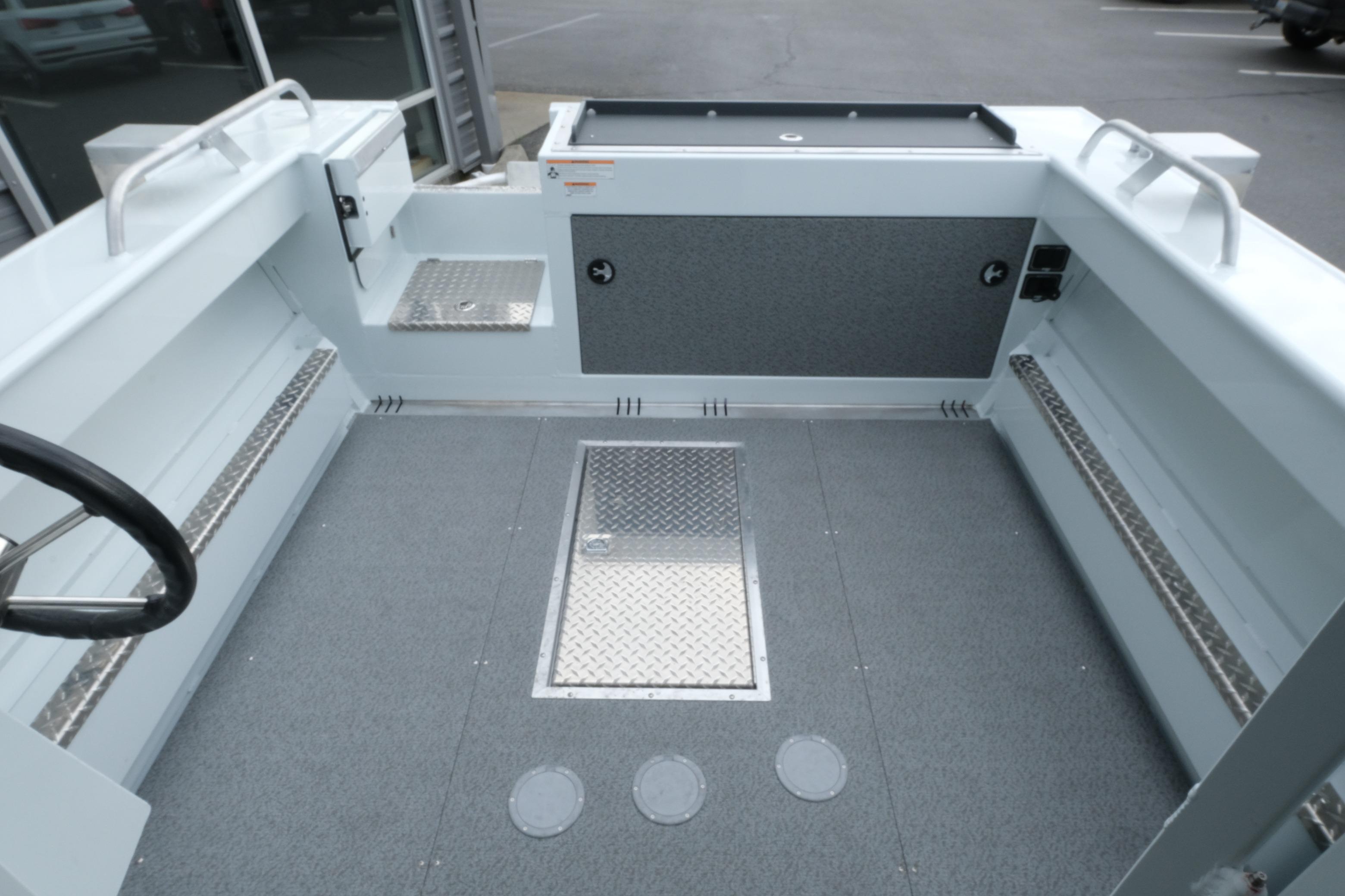 Interior of 2026 Hewescraft 210 Sea Runner ET Hardtop boat, featuring spacious deck and storage.