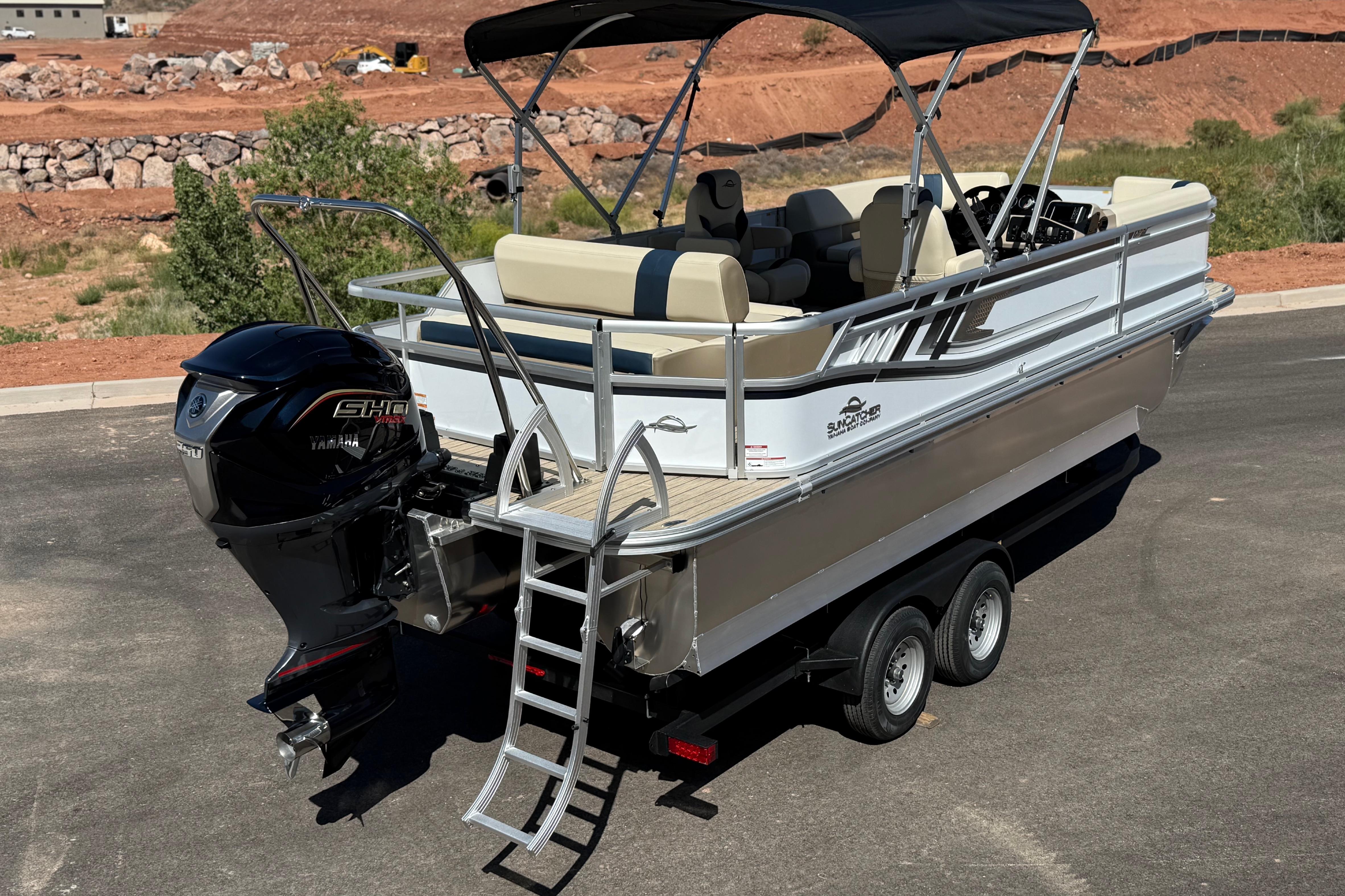 2026 SunCatcher Select 322SL pontoon boat with Yamaha engine on trailer.