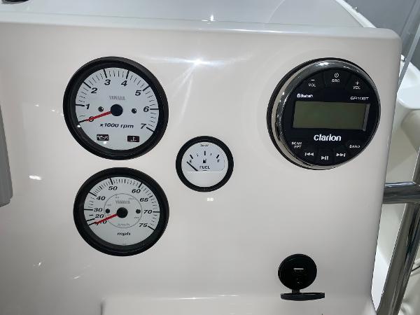Dashboard of 2026 Key West 188 Bay Reef boat with gauges and Clarion audio system.