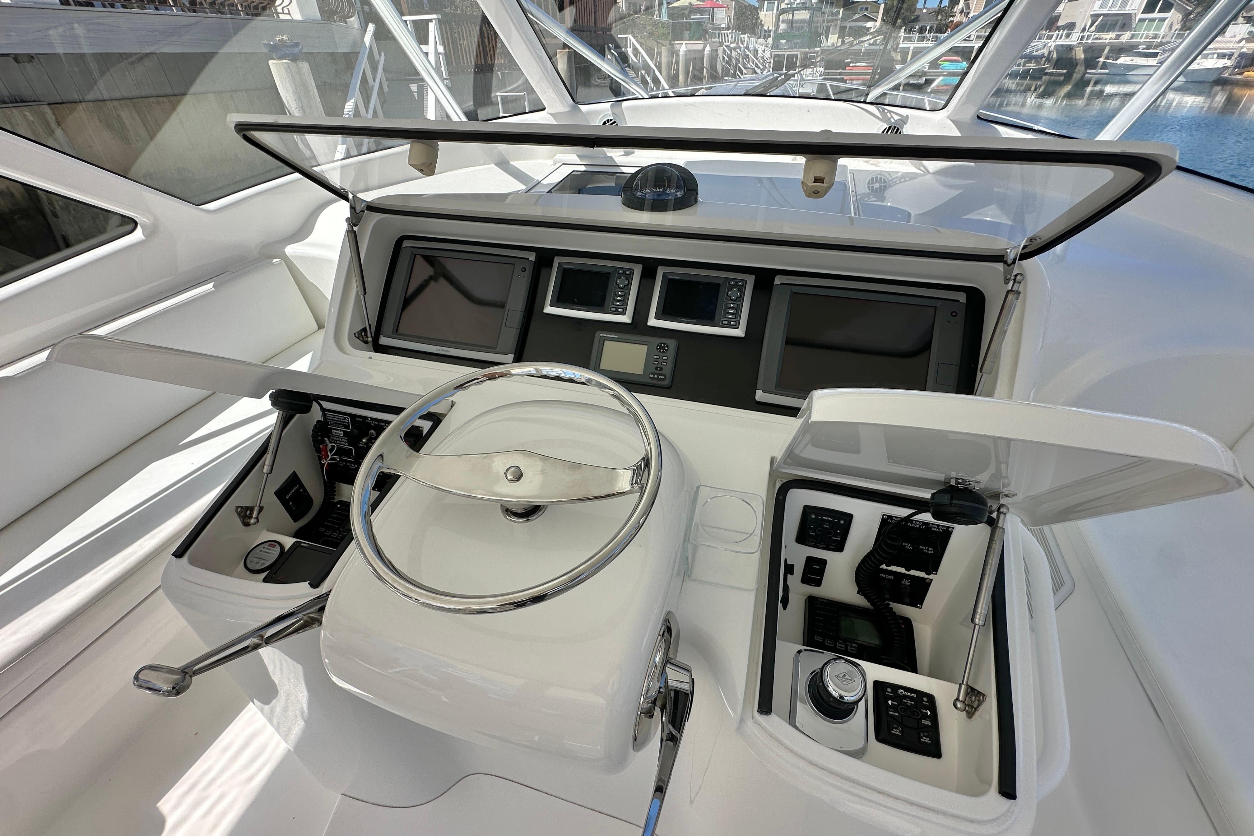 Control panel of a 2012 Viking 42 Open yacht with steering wheel and navigation instruments.