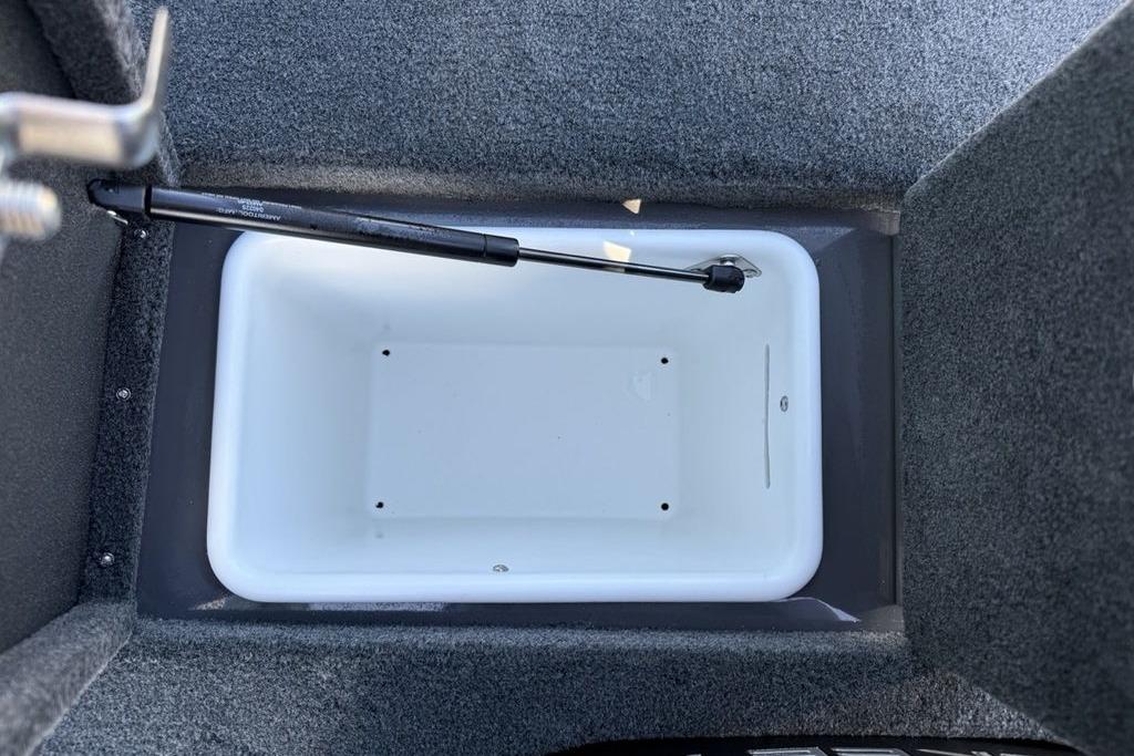 2026 Skeeter ZX150 boat storage compartment with hydraulic lift, carpeted interior.