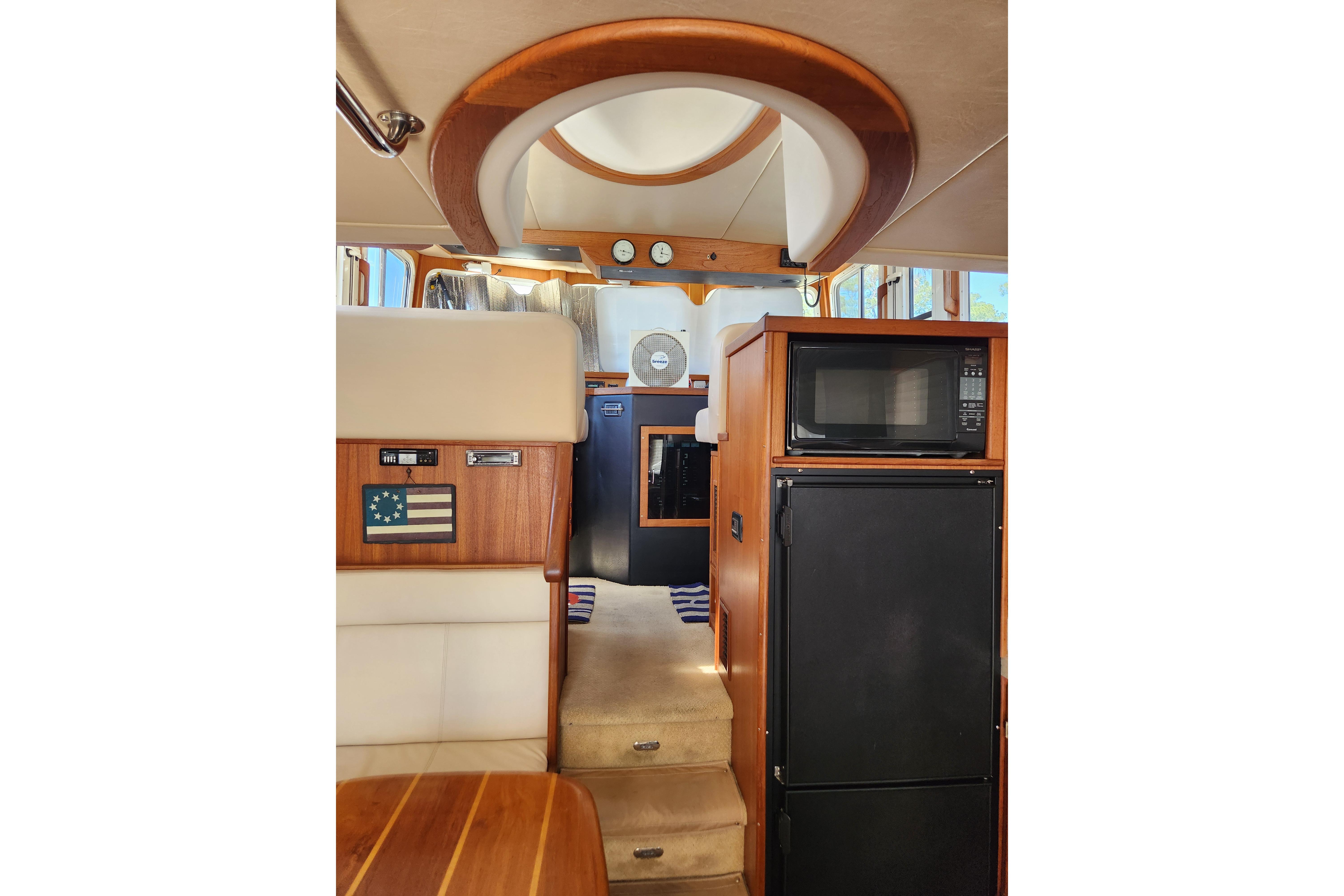 Interior of a 2006 American Tug AT, featuring a microwave and refrigerator.