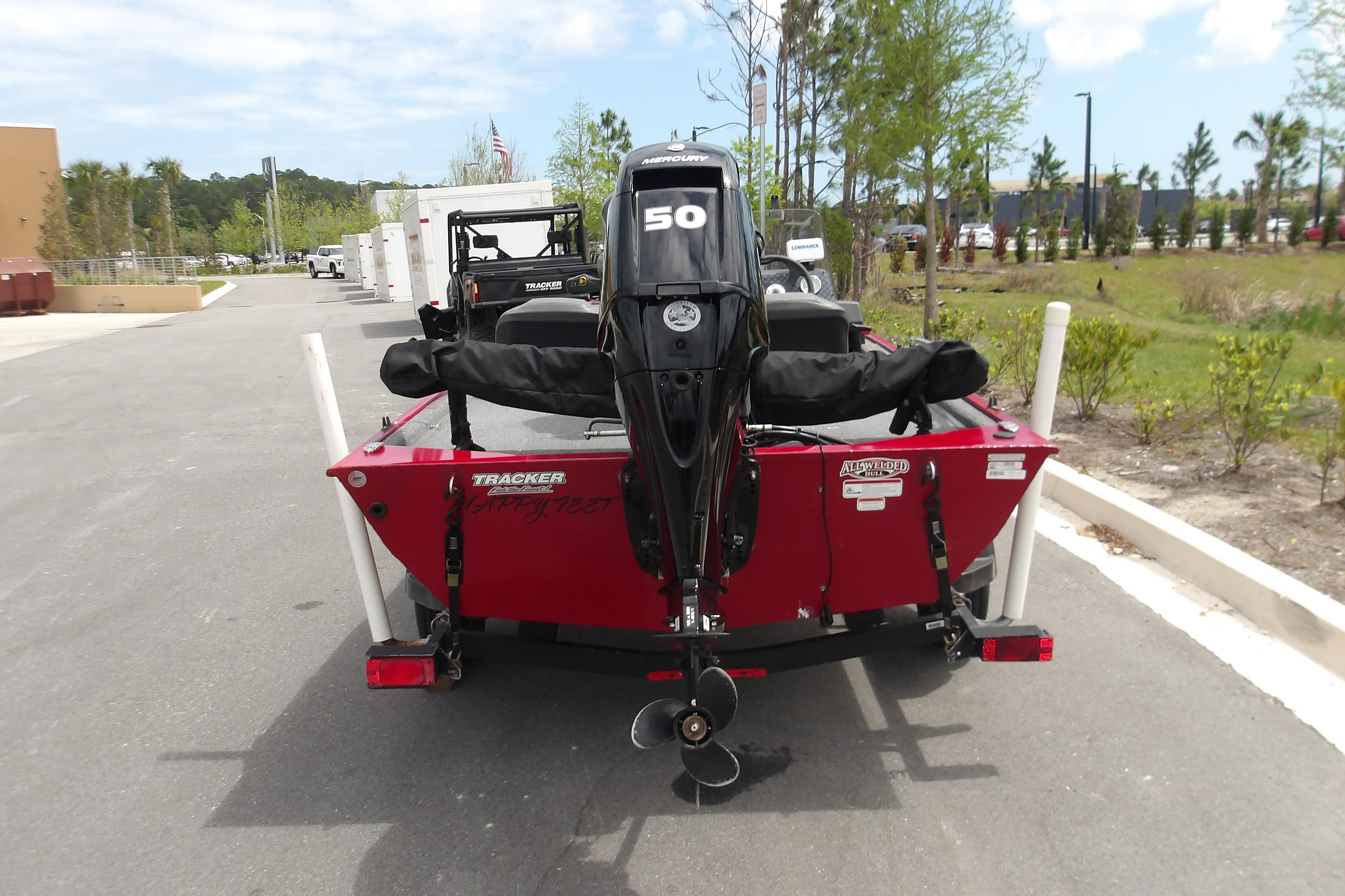 2024 Tracker Bass Tracker Classic XL boat with 50 HP motor, parked outdoors.