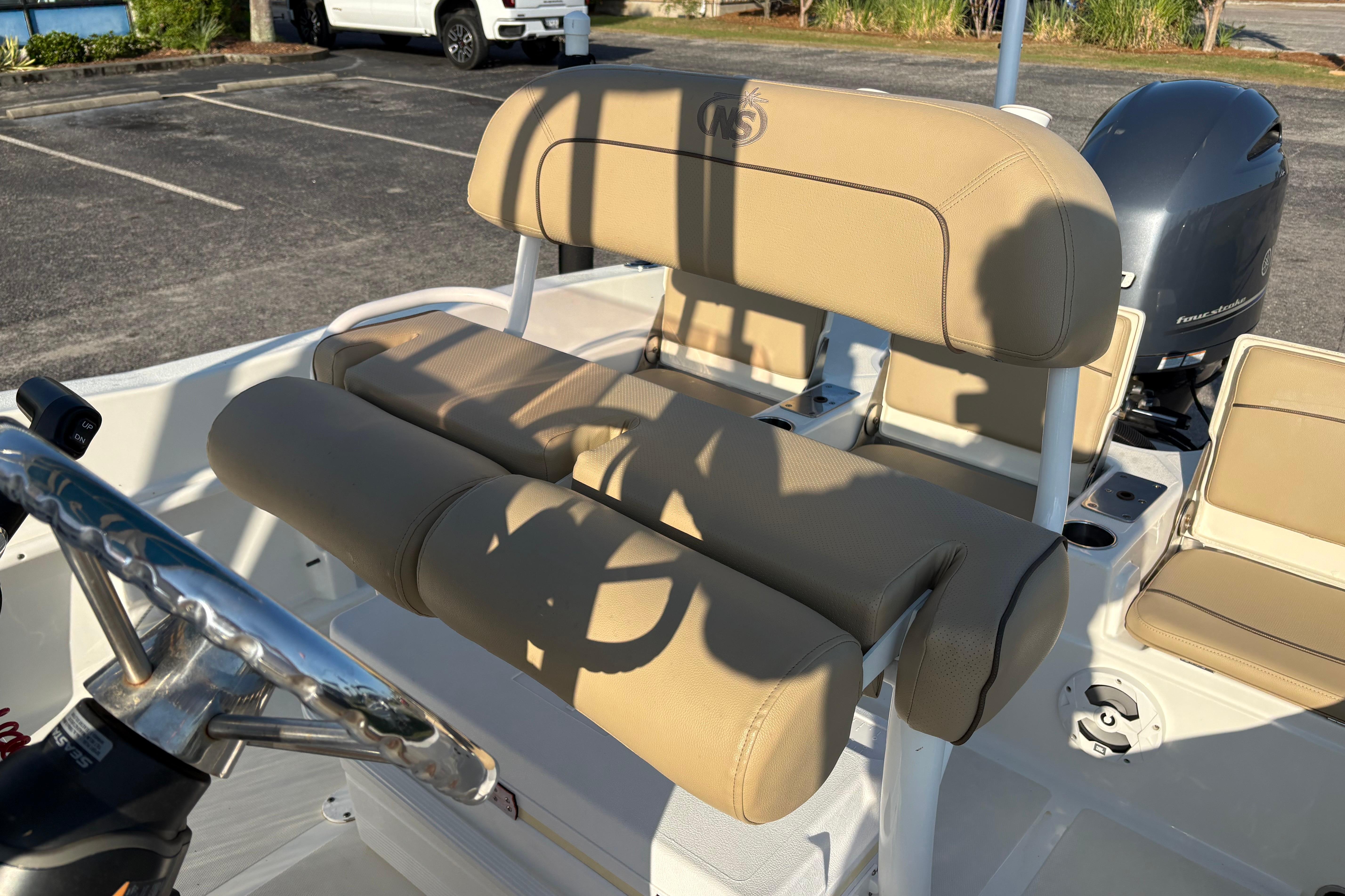 2019 NauticStar 231 Hybrid boat interior with tan seating and steering wheel.