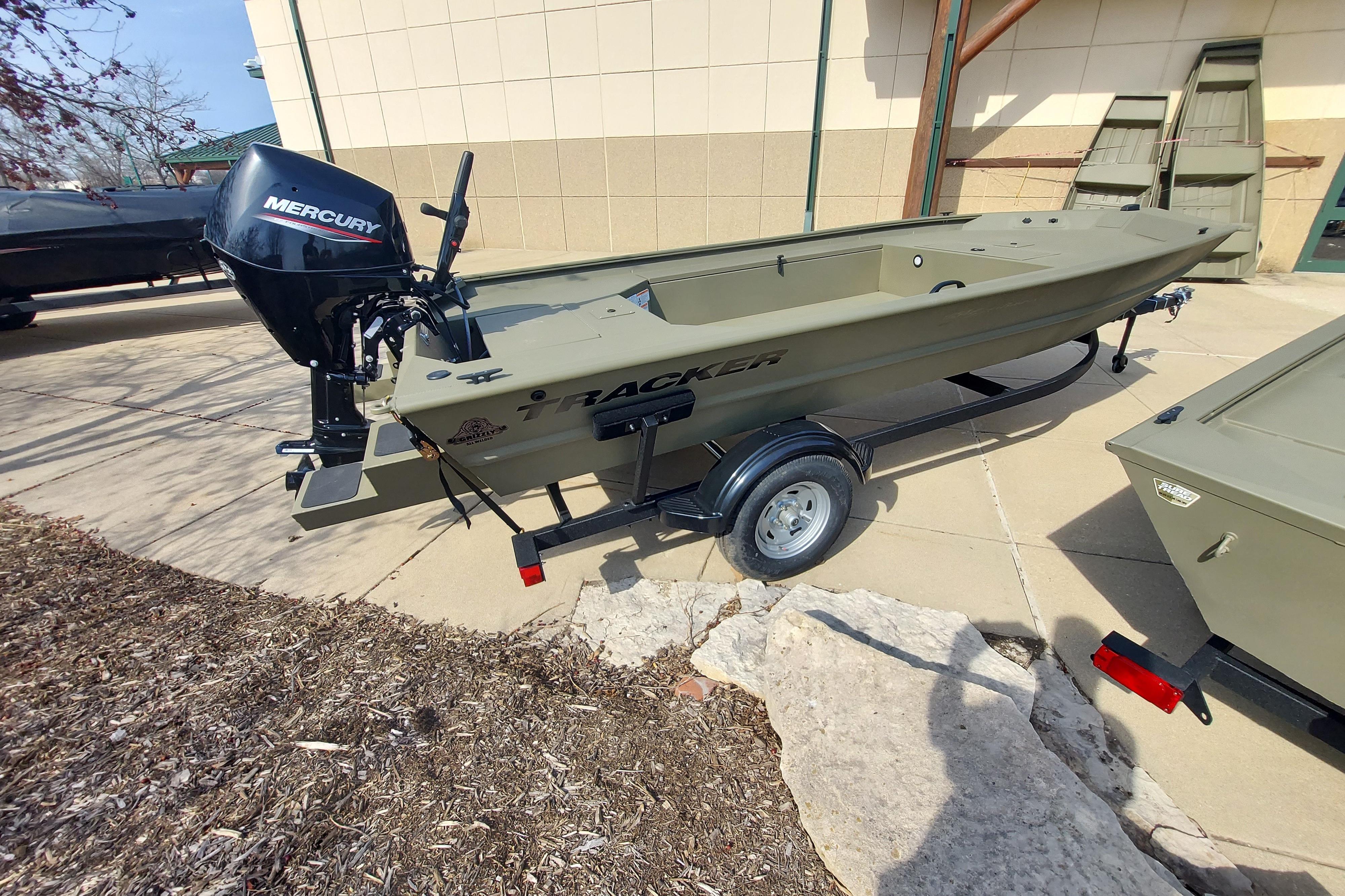 2026 Tracker Grizzly 1654 T Sportsman boat with Mercury engine on trailer.