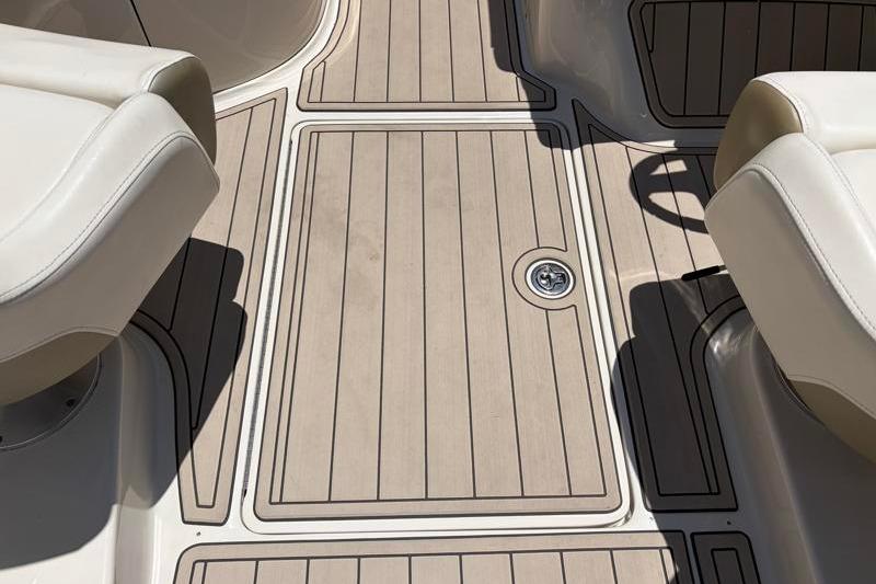 2007 Sea Ray 240 Sundeck boat interior with beige seating and teak-style flooring.