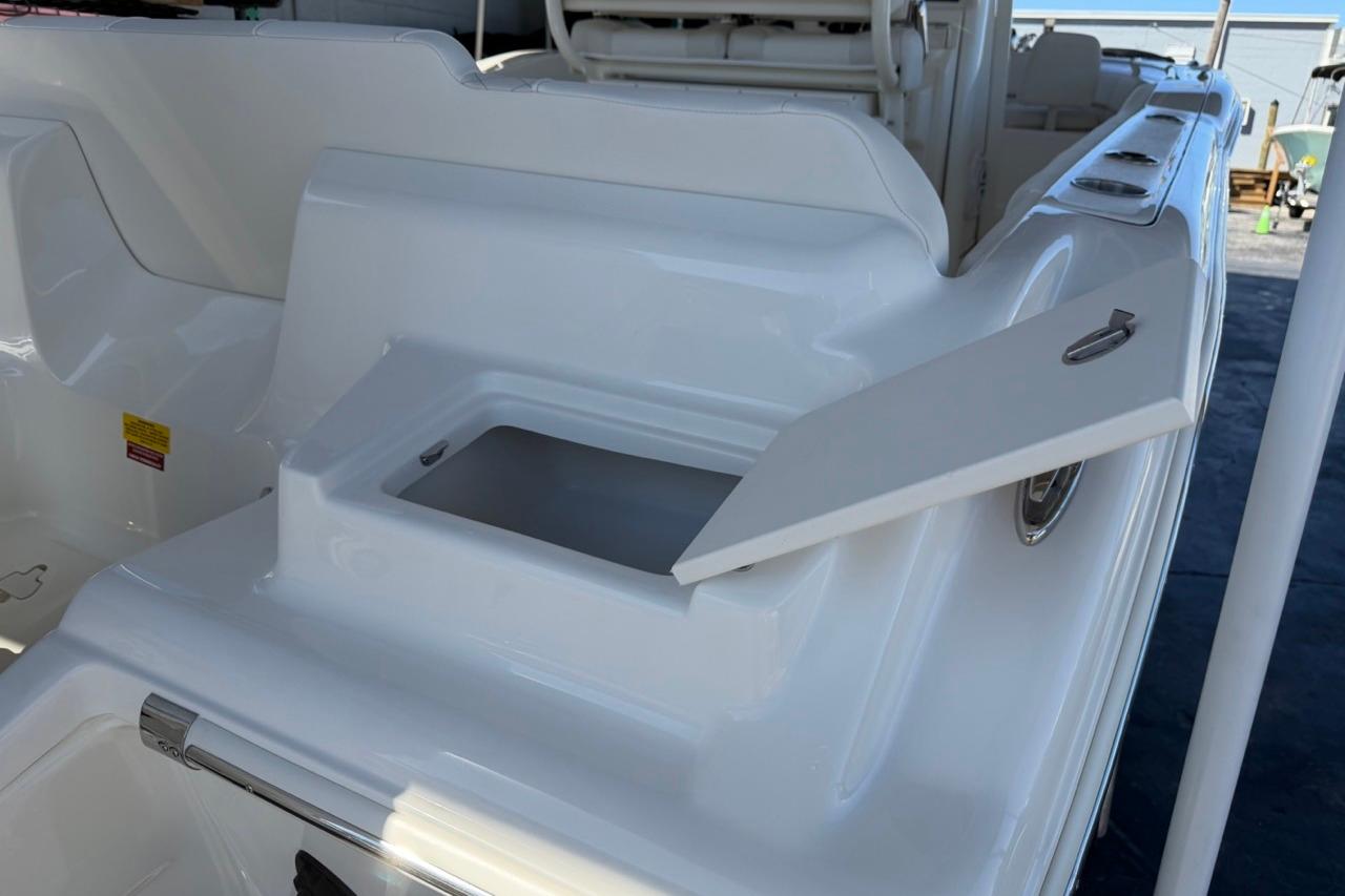 2026 Key West 239 FSR boat with open storage compartment on deck.