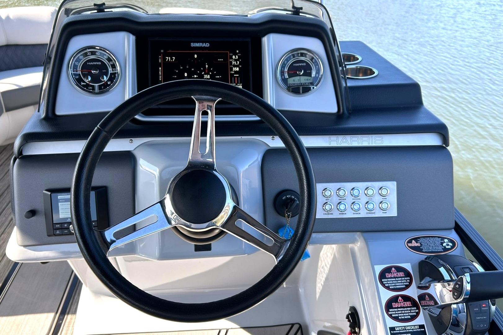 2020 Harris FloteBote Solstice 230 dashboard with steering wheel and control panel.