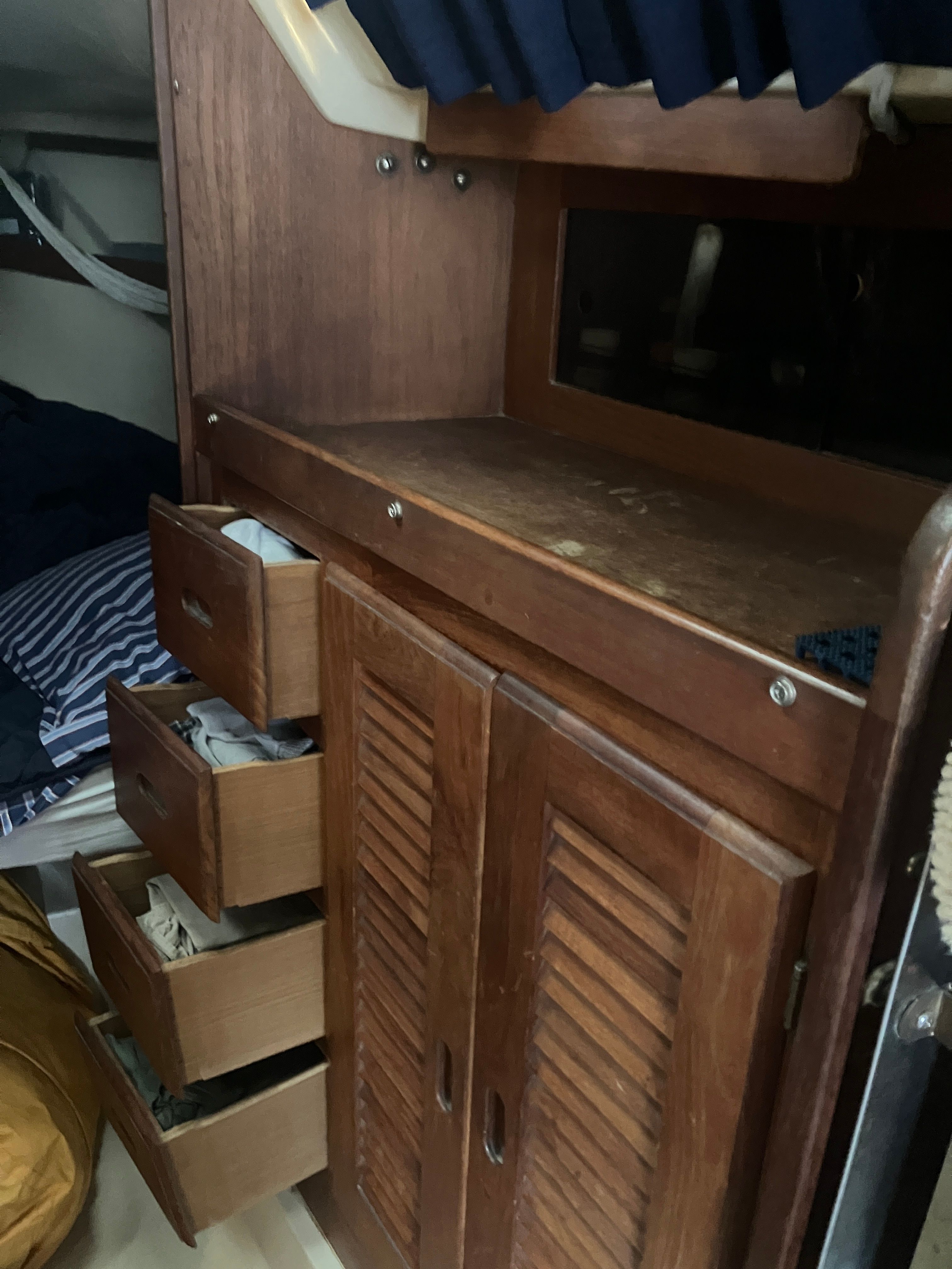 Interior of a 1984 Catalina 30 with wooden cabinets and drawers.