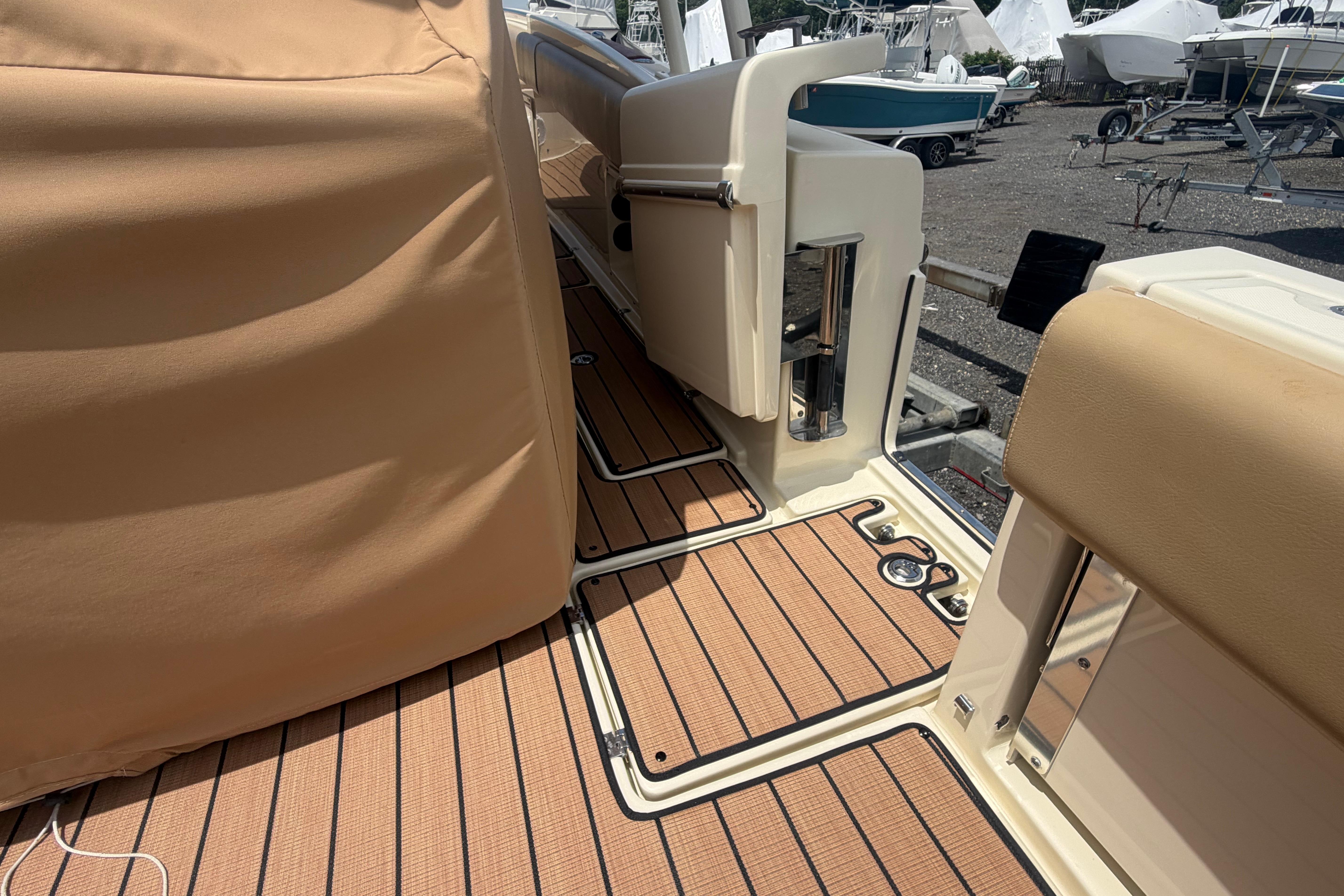 2017 Chris-Craft Catalina 34 boat deck with tan upholstery and wood flooring.