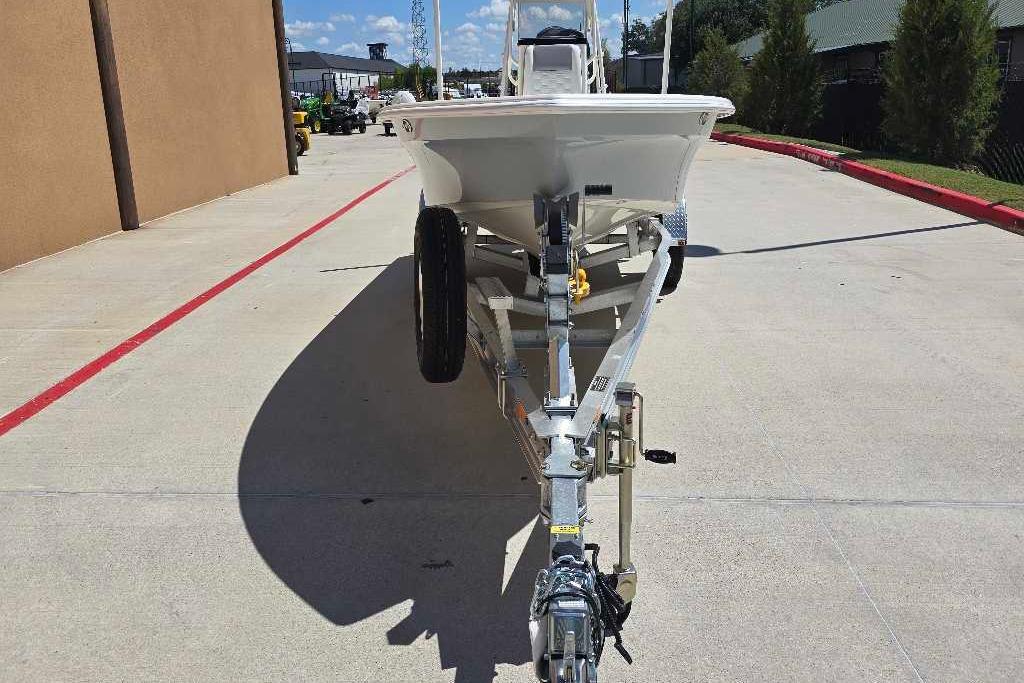 2026 Mako 18 Pro Skiff boat on trailer, parked outdoors.