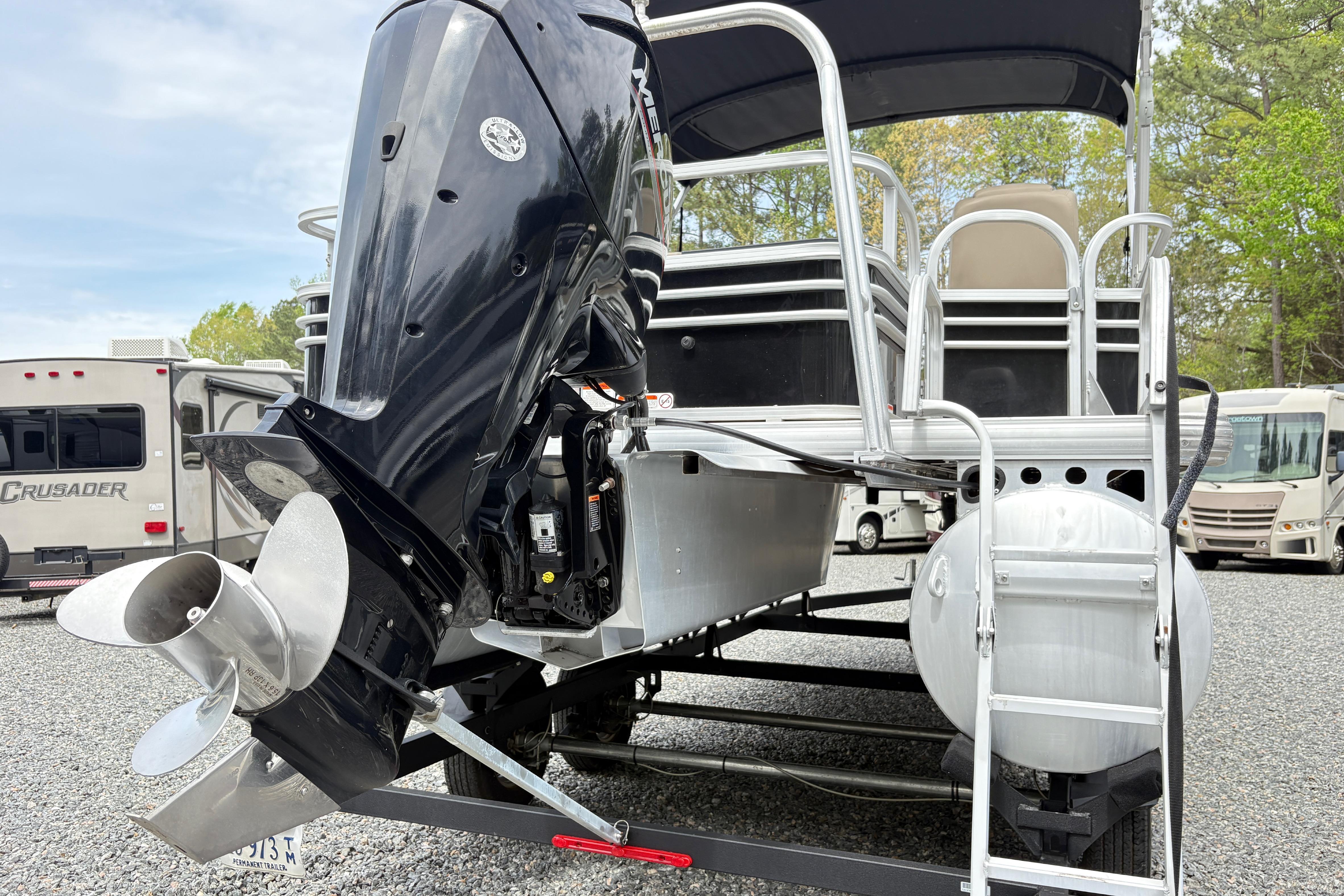 2021 Sun Tracker Fishin' Barge 20 DLX pontoon boat with outboard motor.